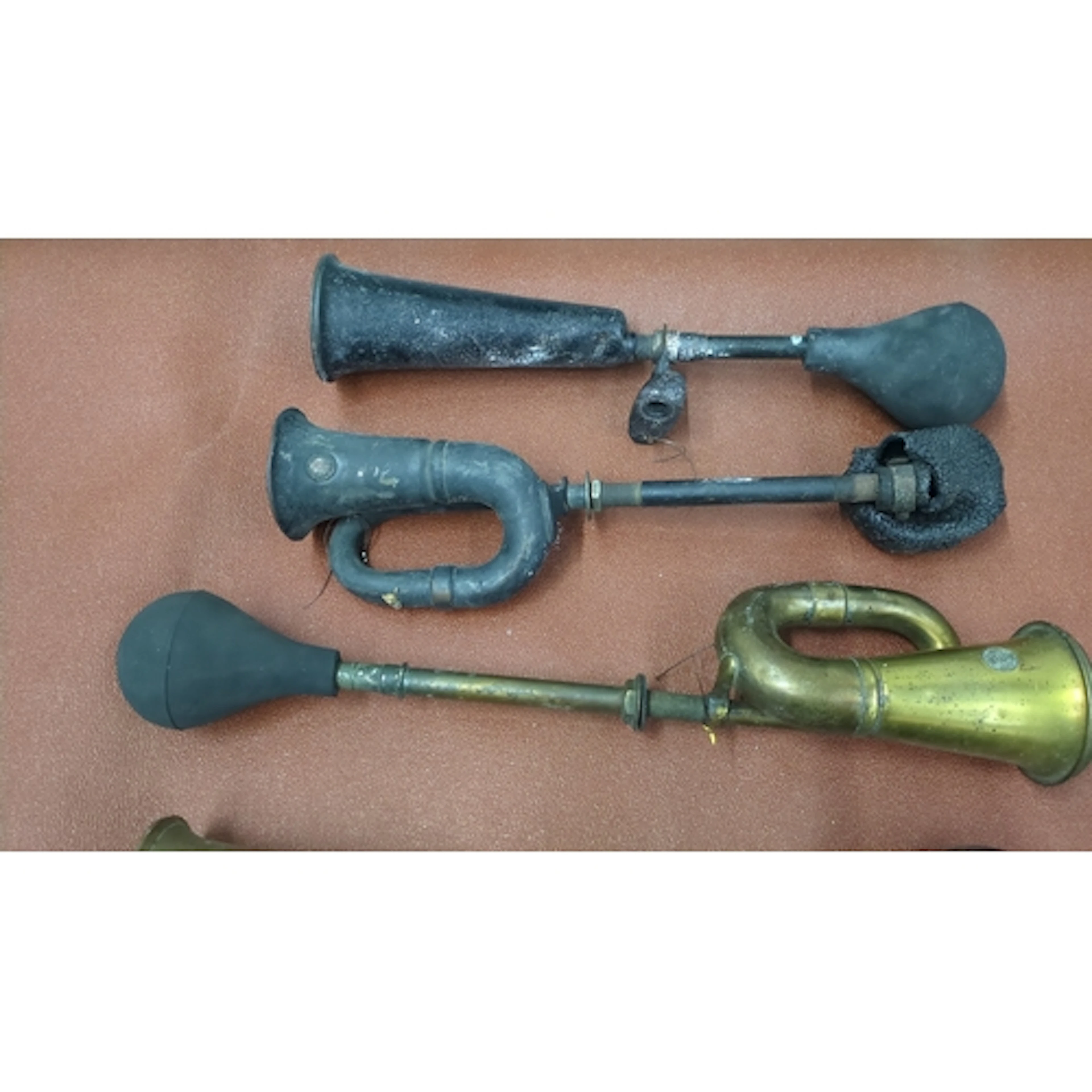 A group of vintage bulb horns, including brass and painted m...