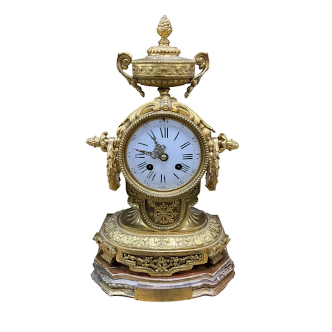 A 19th century French ormolu mantel clock, with urn surmount...