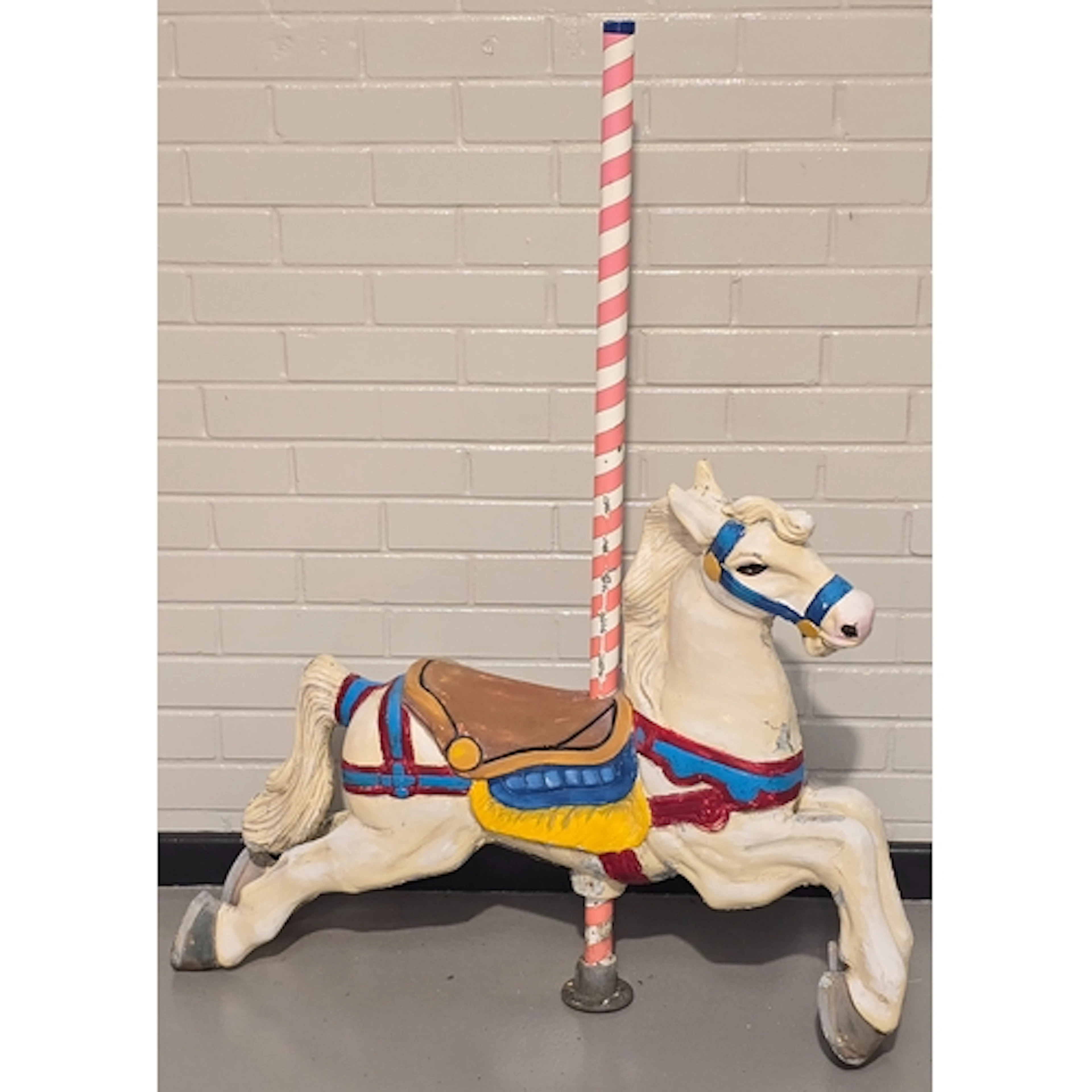A vintage metal painted merry-go-round horse with pole. Pole...