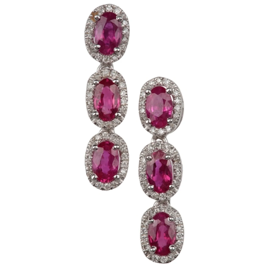 A pair of ruby and diamond earrings, each of drop design, se...