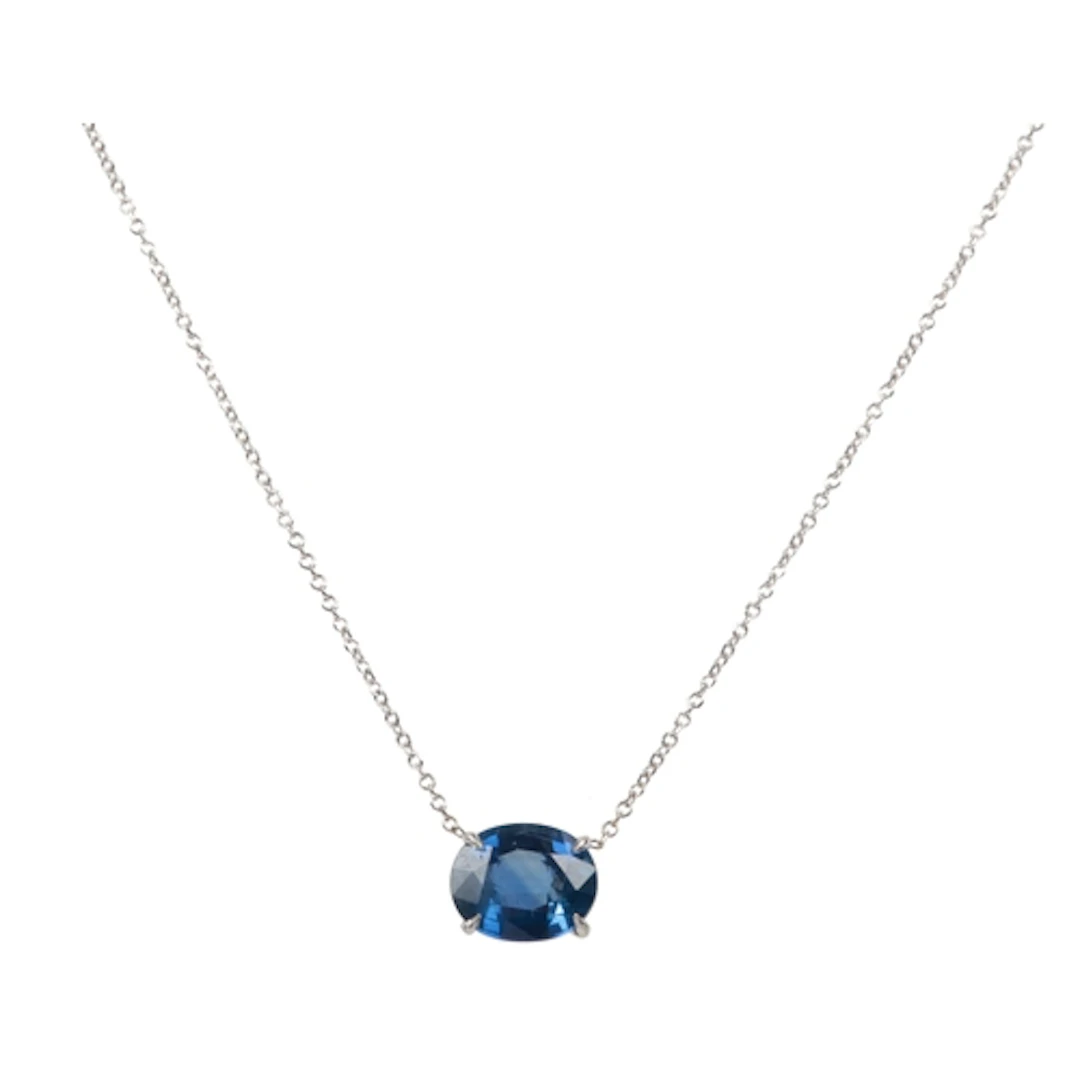 A sapphire pendant, claw-set with an oval sapphire measuring...