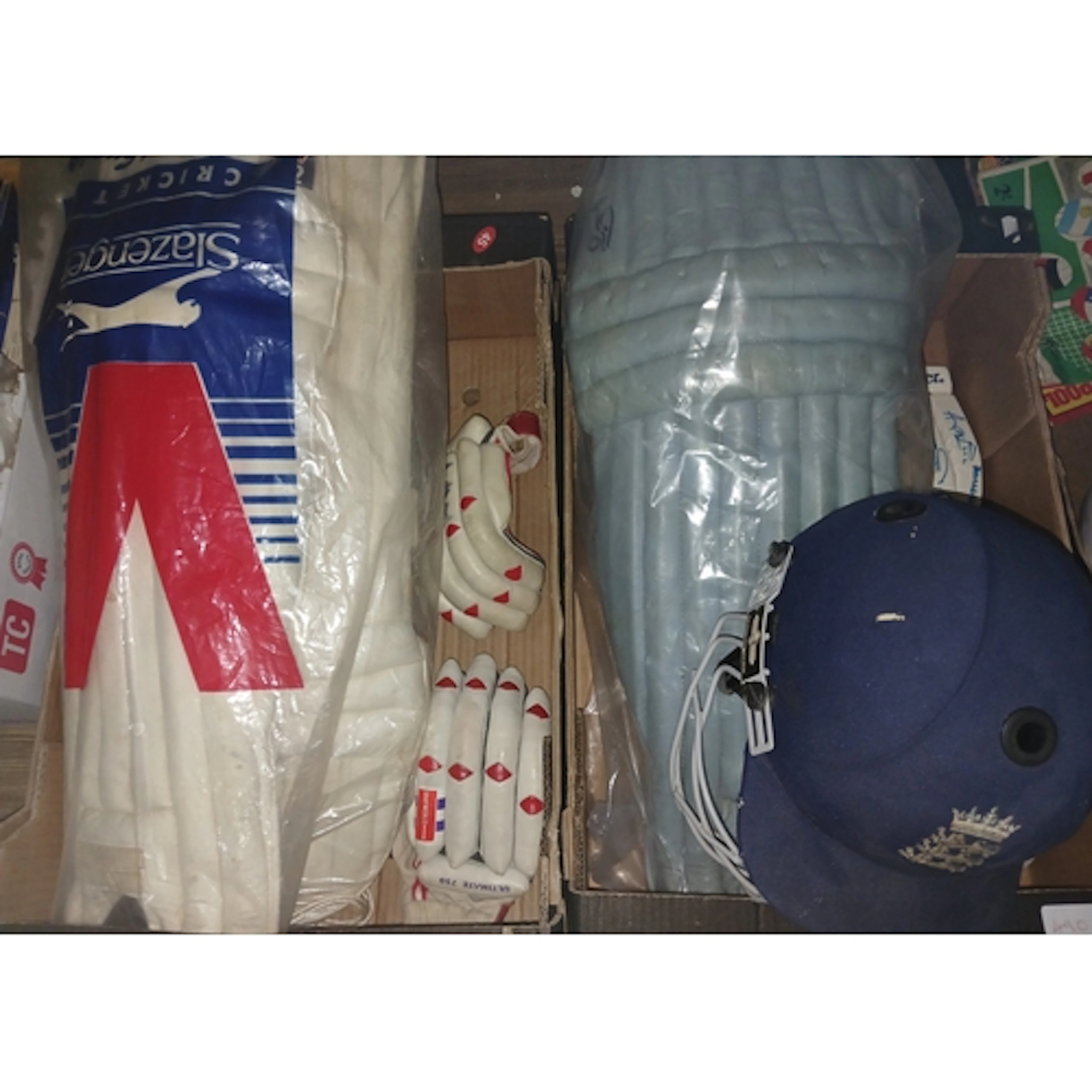 Two boxes of assorted cricket related items comprising of a ...
