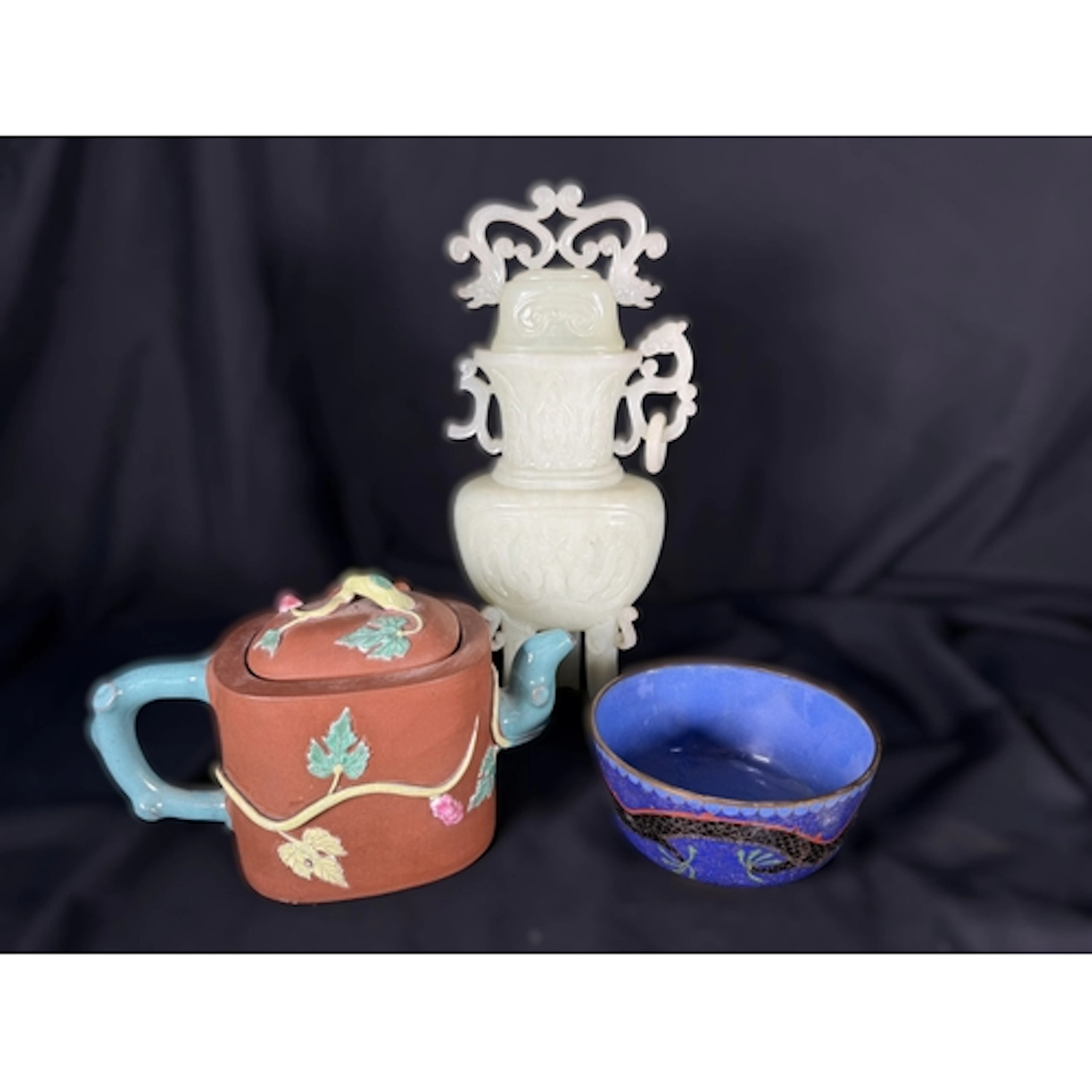 A Chinese Yixing teapot with coloured relief, decorative sea...