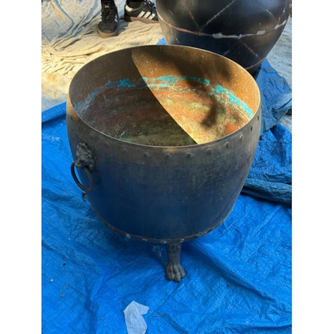 A COPPER LOG BASKET With lion head handles. 47cm H x 49cm D...