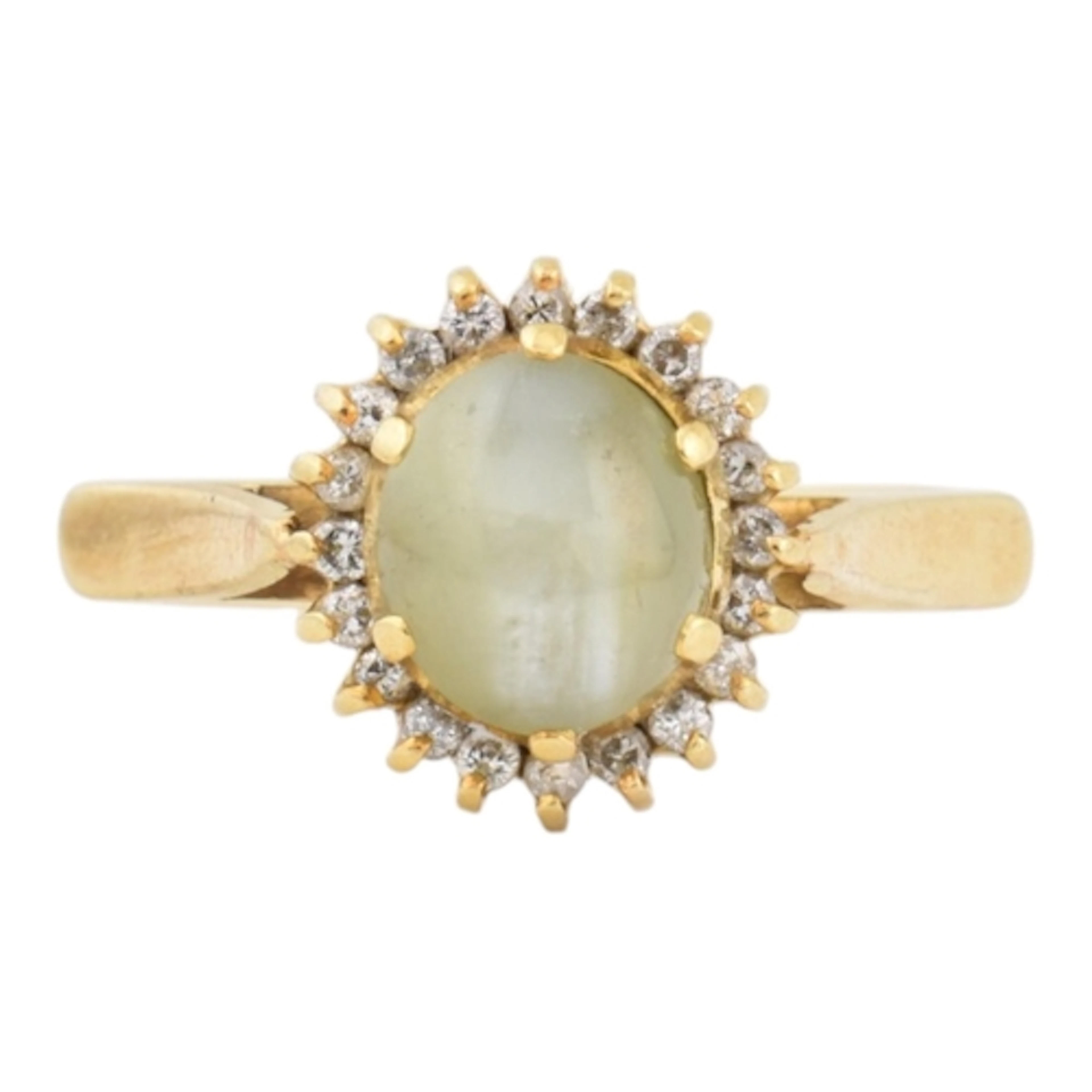 An 18ct gold, cat's eye chrysoberyl and diamond halo ring. T...