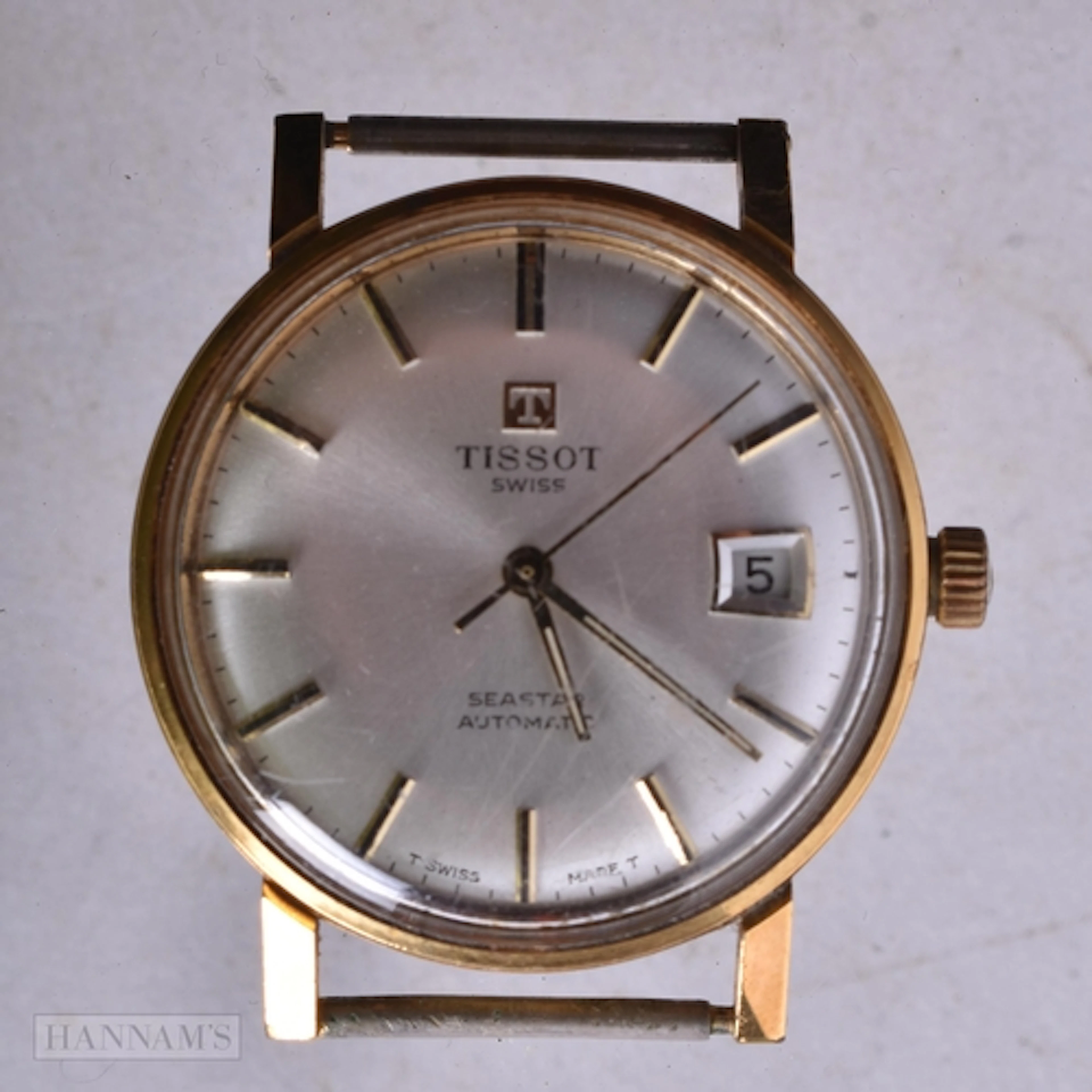 A TISSOT WATCH. Running. 3.5 cm wide.