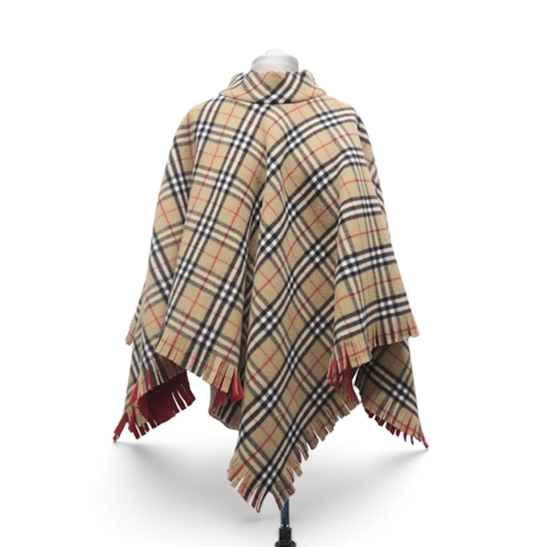 A Burberry wool poncho in nova check with red backing