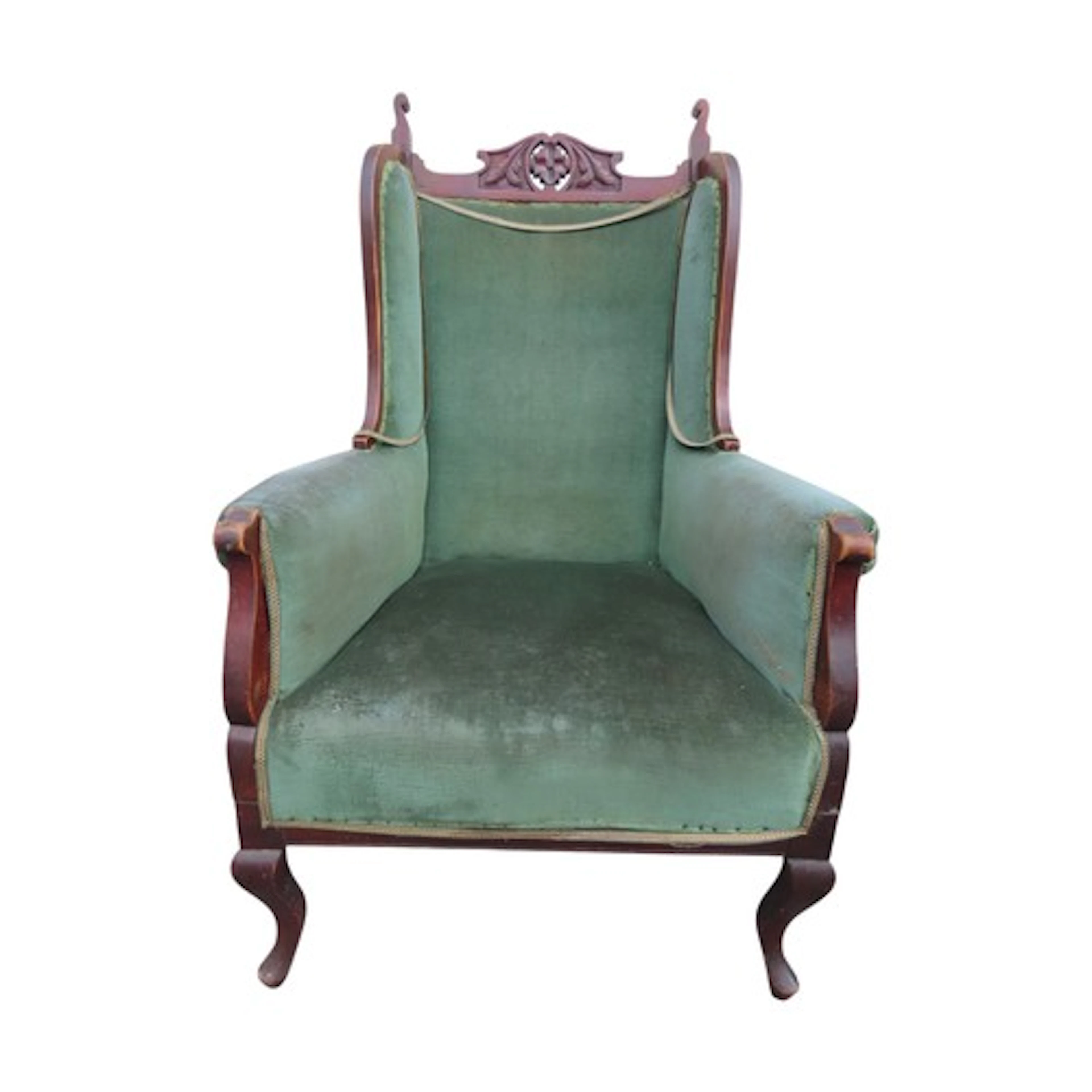 An Edwardian wing armchair with green upholstery and show wo...
