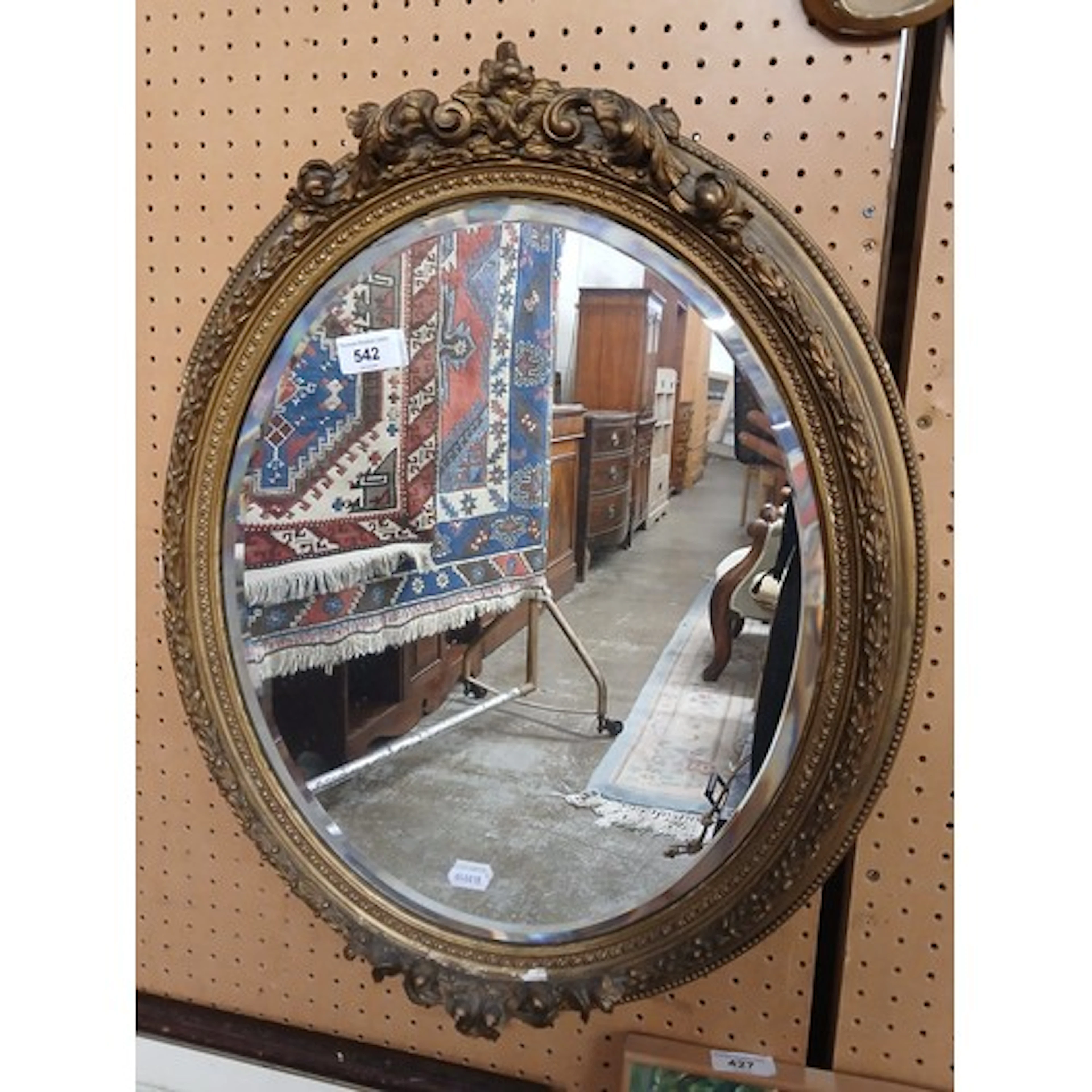 Gilt framed oval mirror.