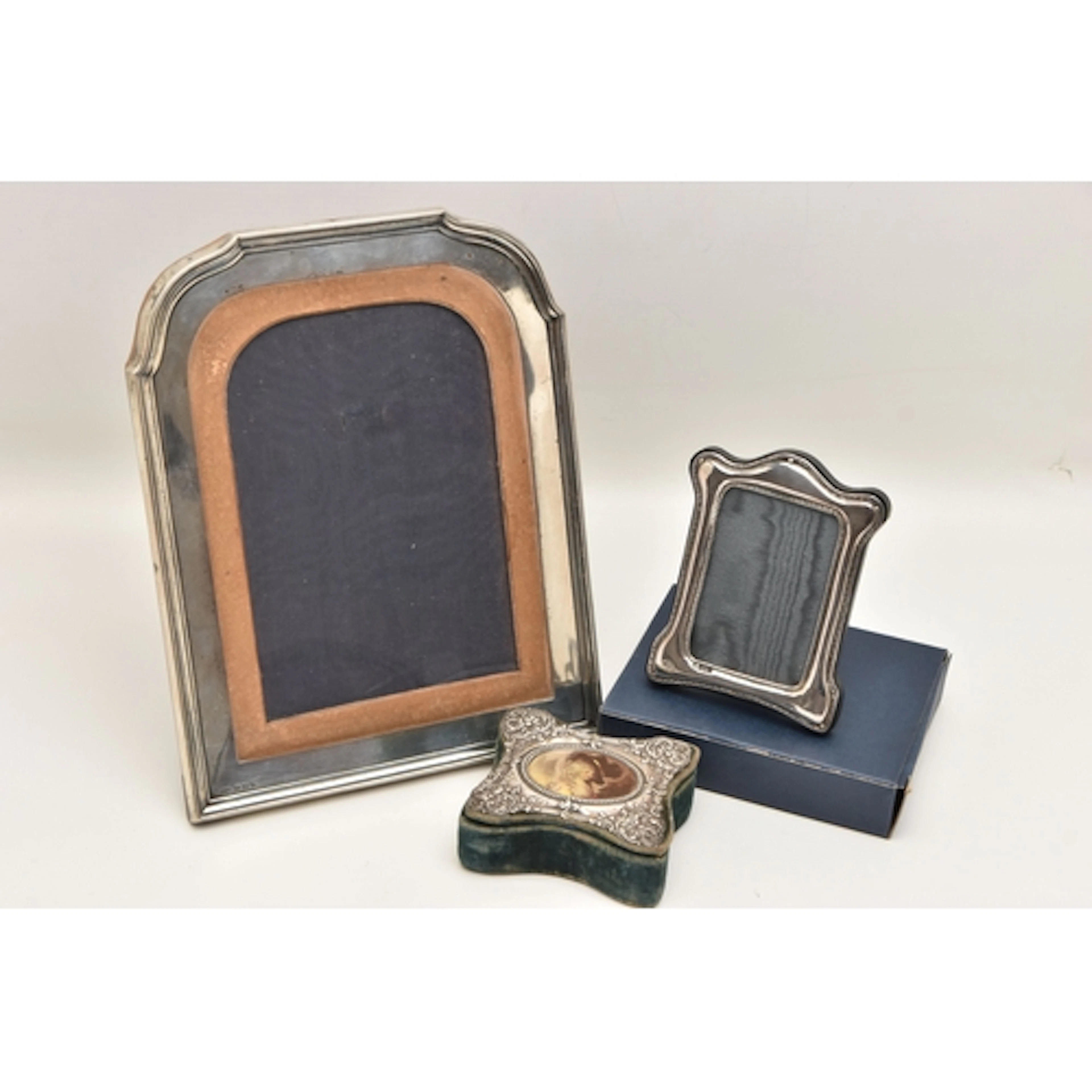 TWO SILVER PHOTO FRAMES AND A SILVER LINED TRINKET BOX, the ...