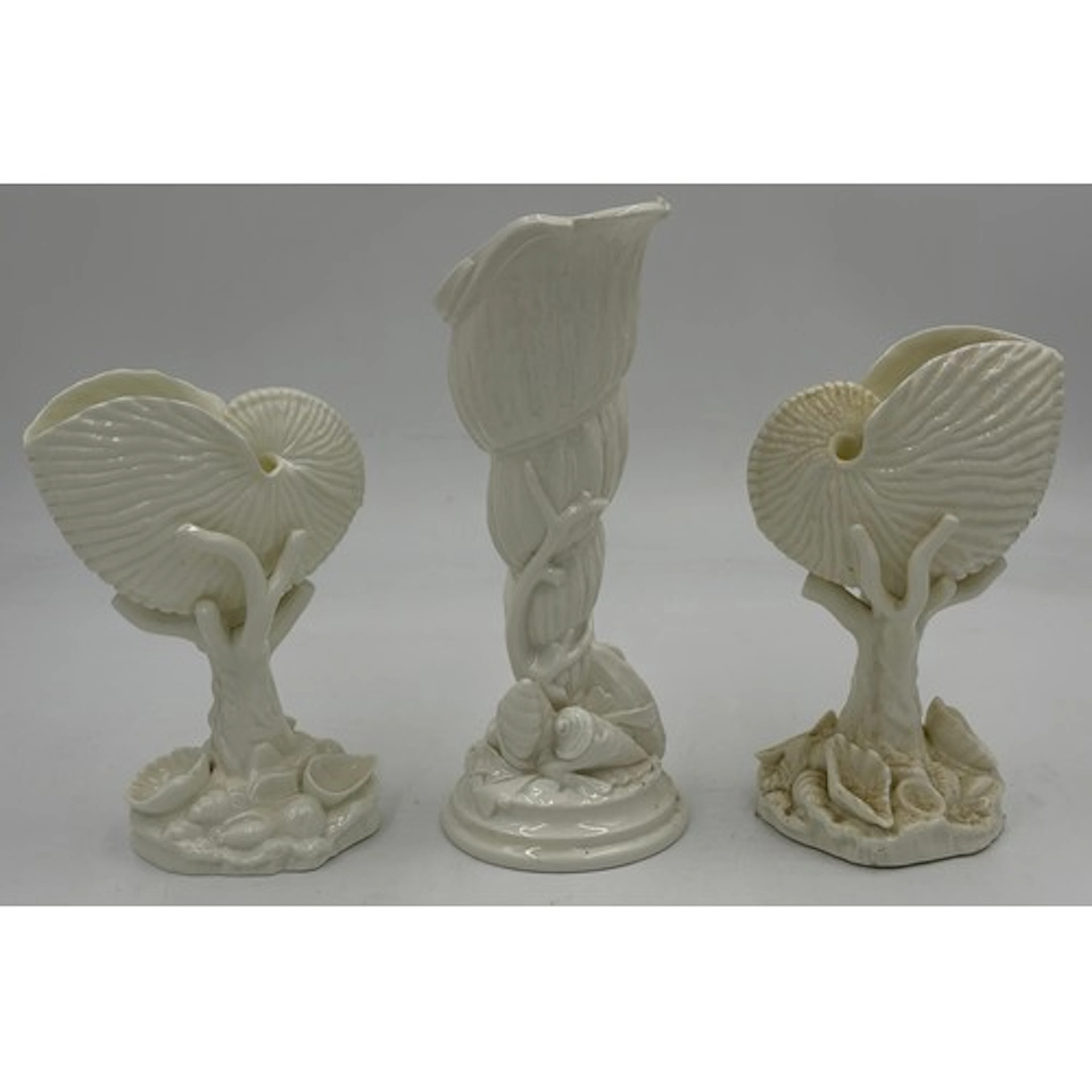 A Pair of Royal Worcester white glazed Nautilus shell vases,...