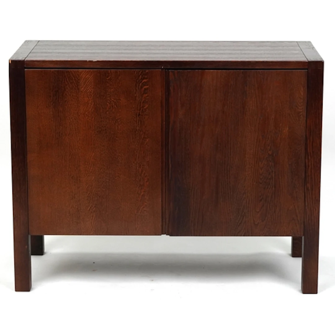 A modern oak side cabinet fitted with a pair of doors, on bl...