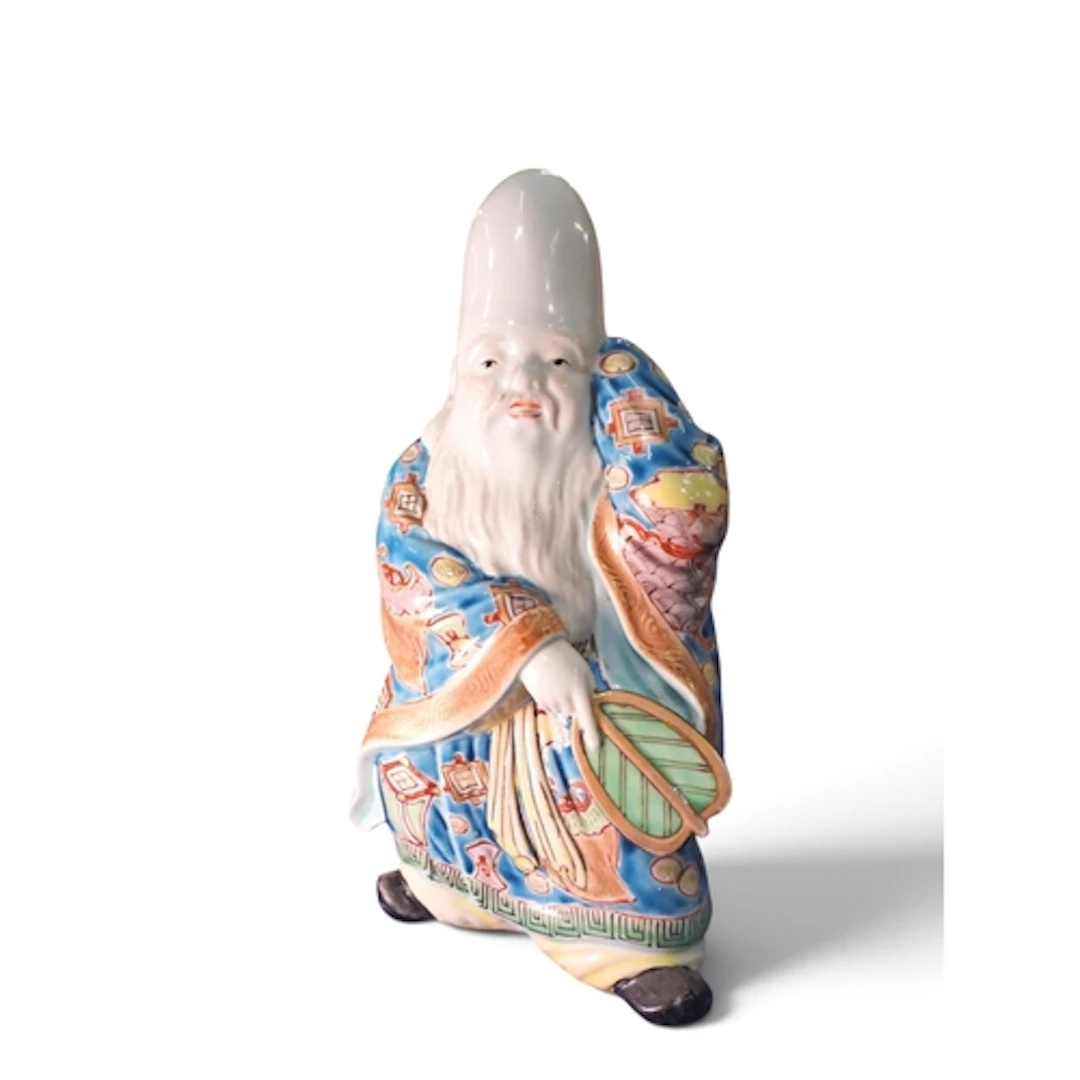 A figure of Fukurokuju Standing wearing flowing robes ...