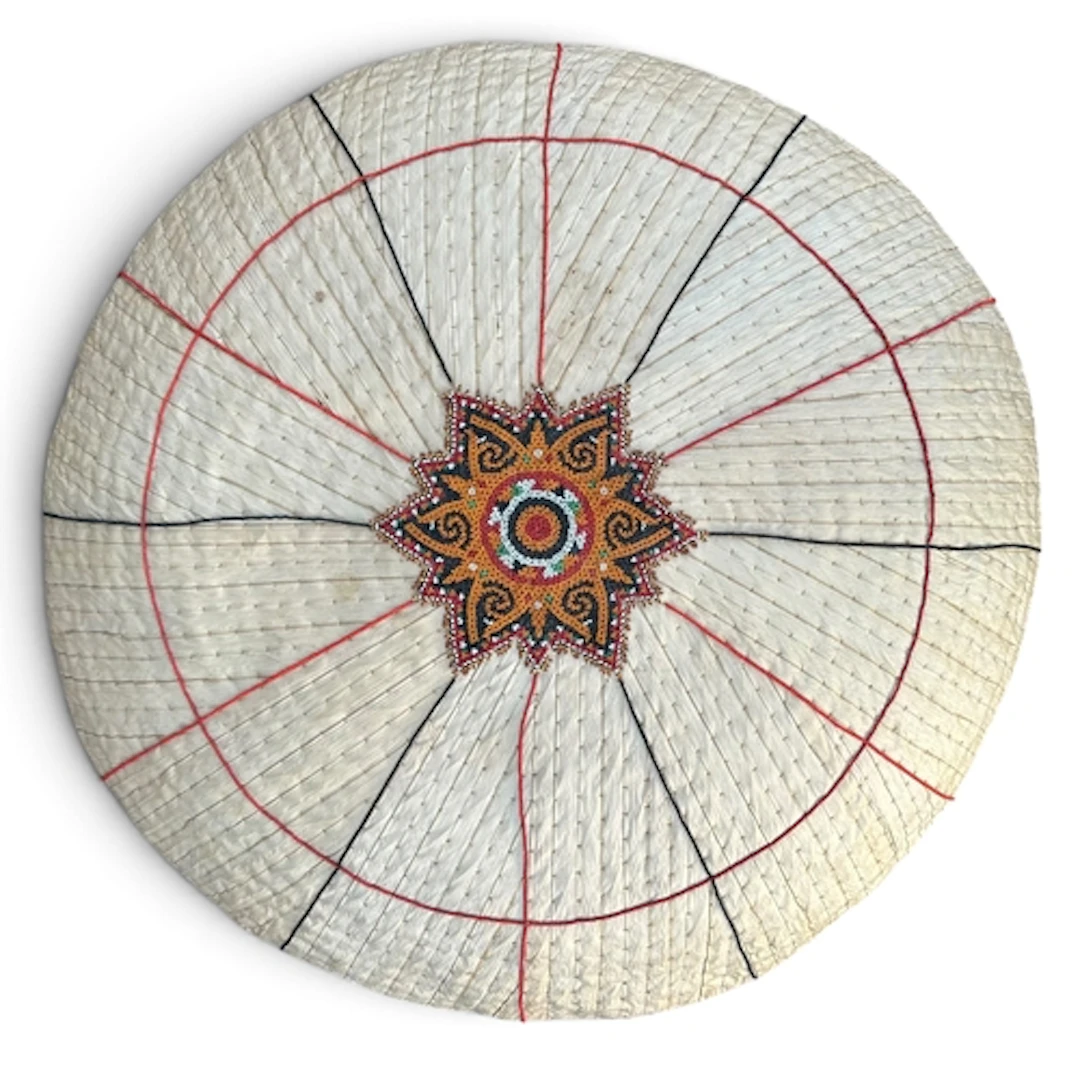 AN EARLY 20TH CENTURY TRIBAL DAYAK PALM LEAF AND CANE SUN HA...