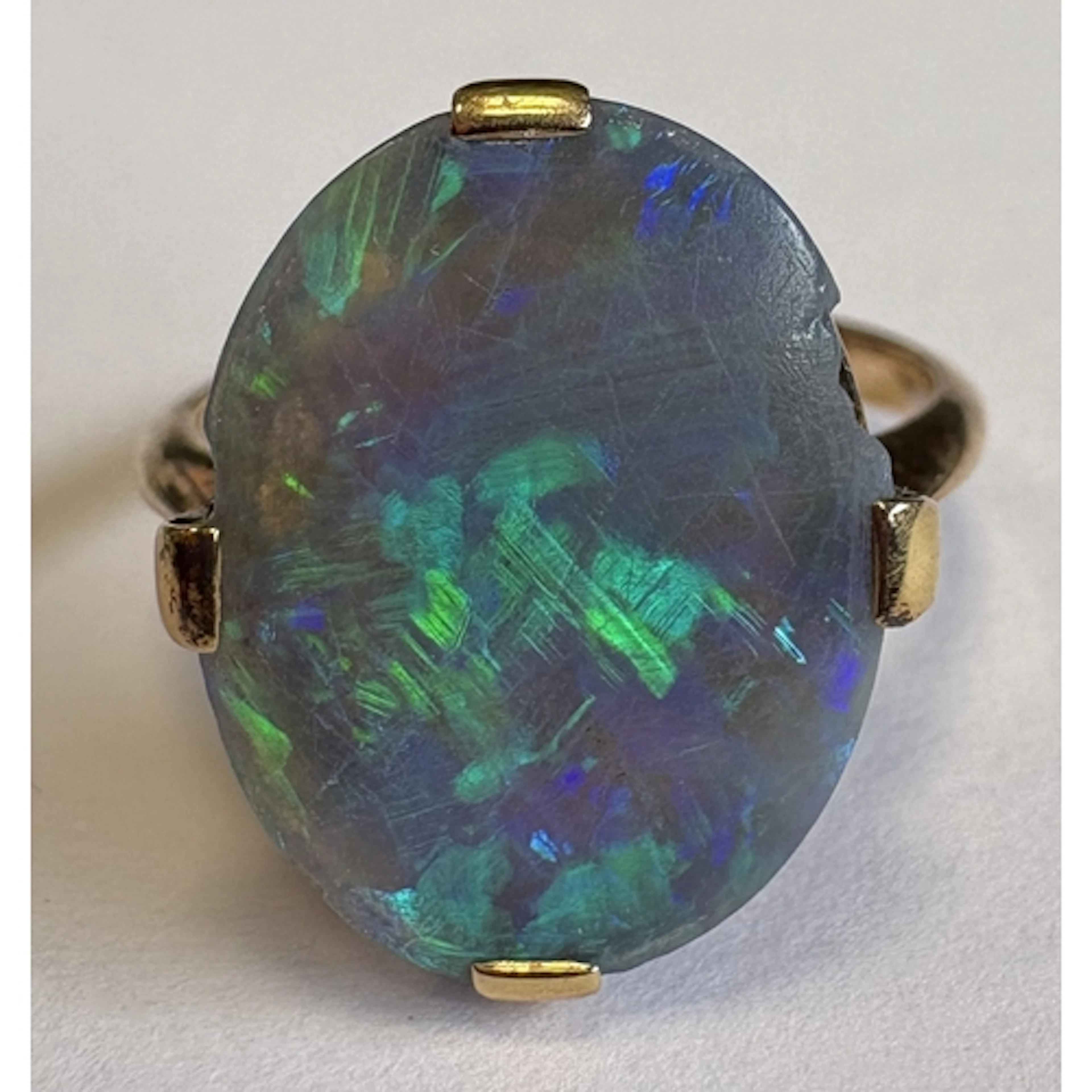 A single-stone opal ring in 9 carat claw mount. Approx. fing...