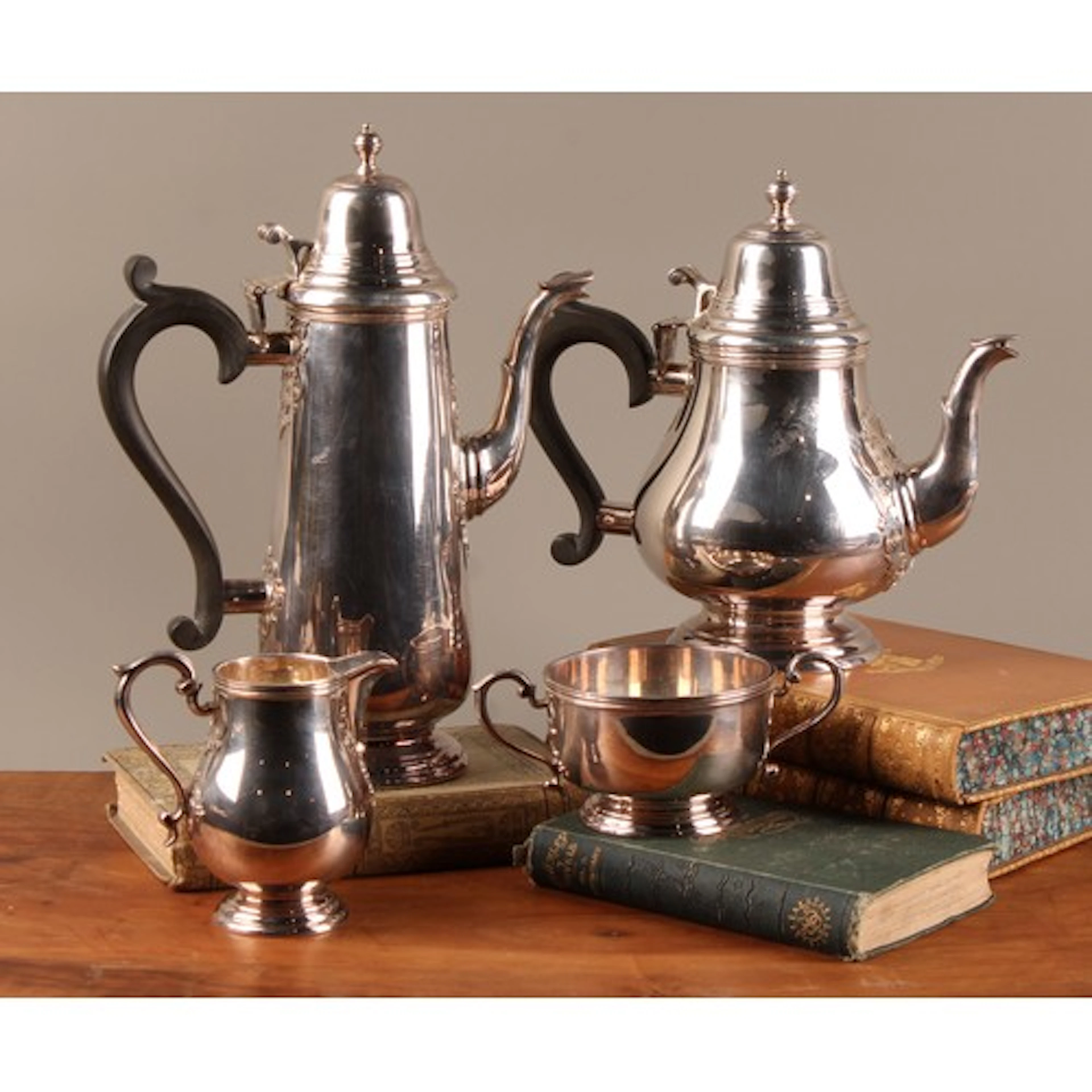An Elizabeth II silver four piece service, double scrolling ...