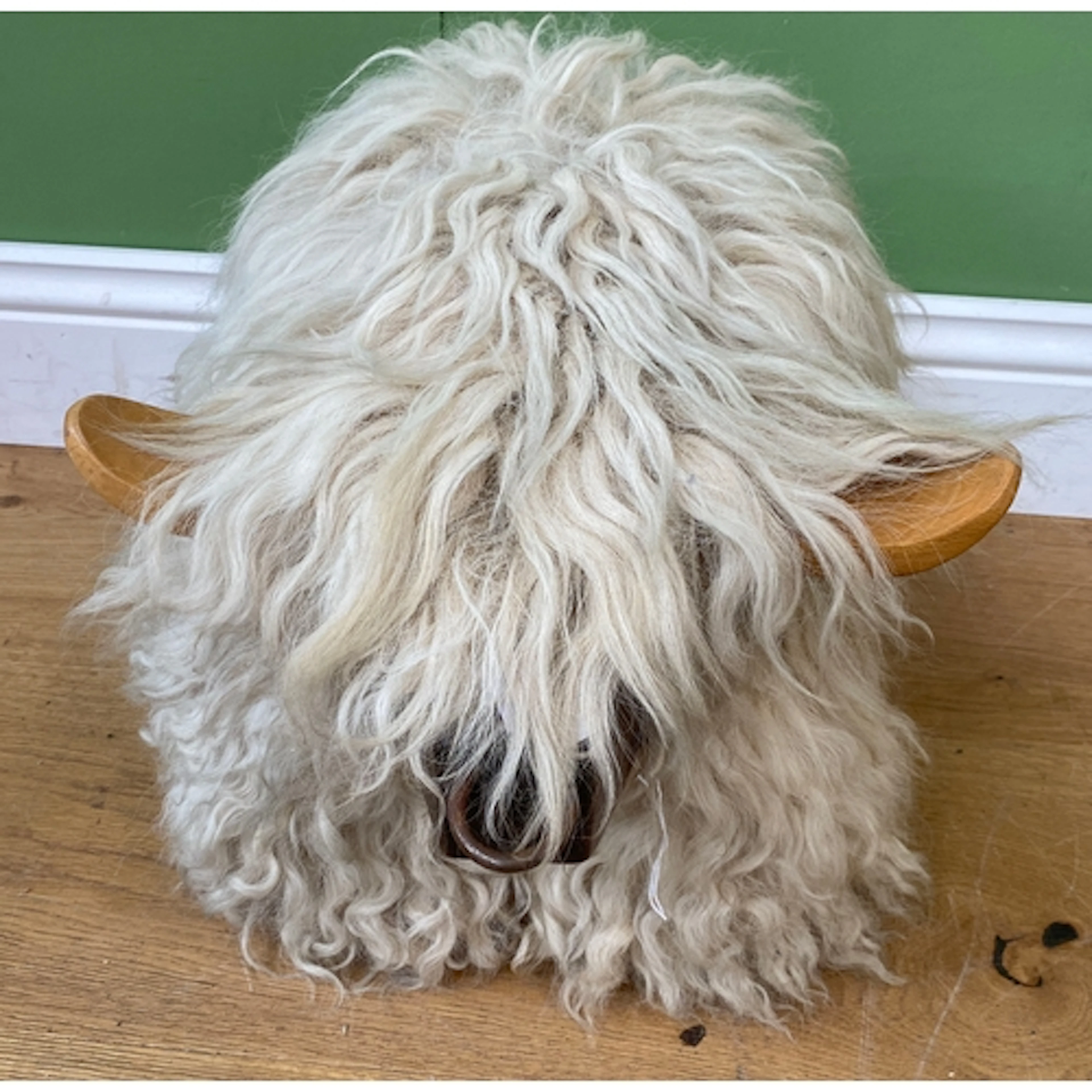 A cute sheepskin clad highland cow stool, 31cmH