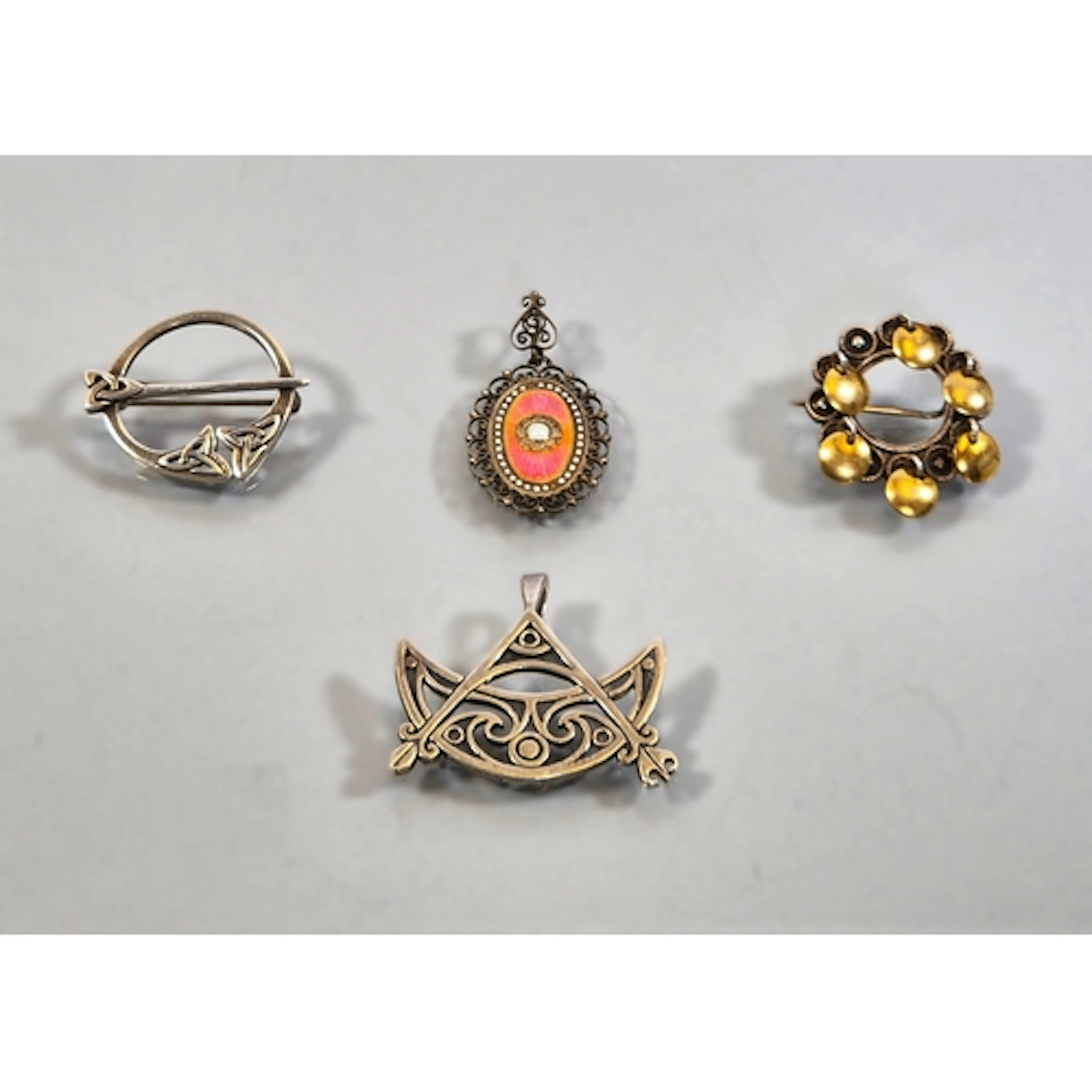 Four silver brooches and pendants to include a Norwegian gui...