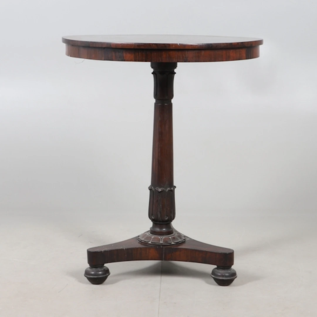 A WILLIAM IV ROSEWOOD TRIPOD TABLE. the circular top upon a ...