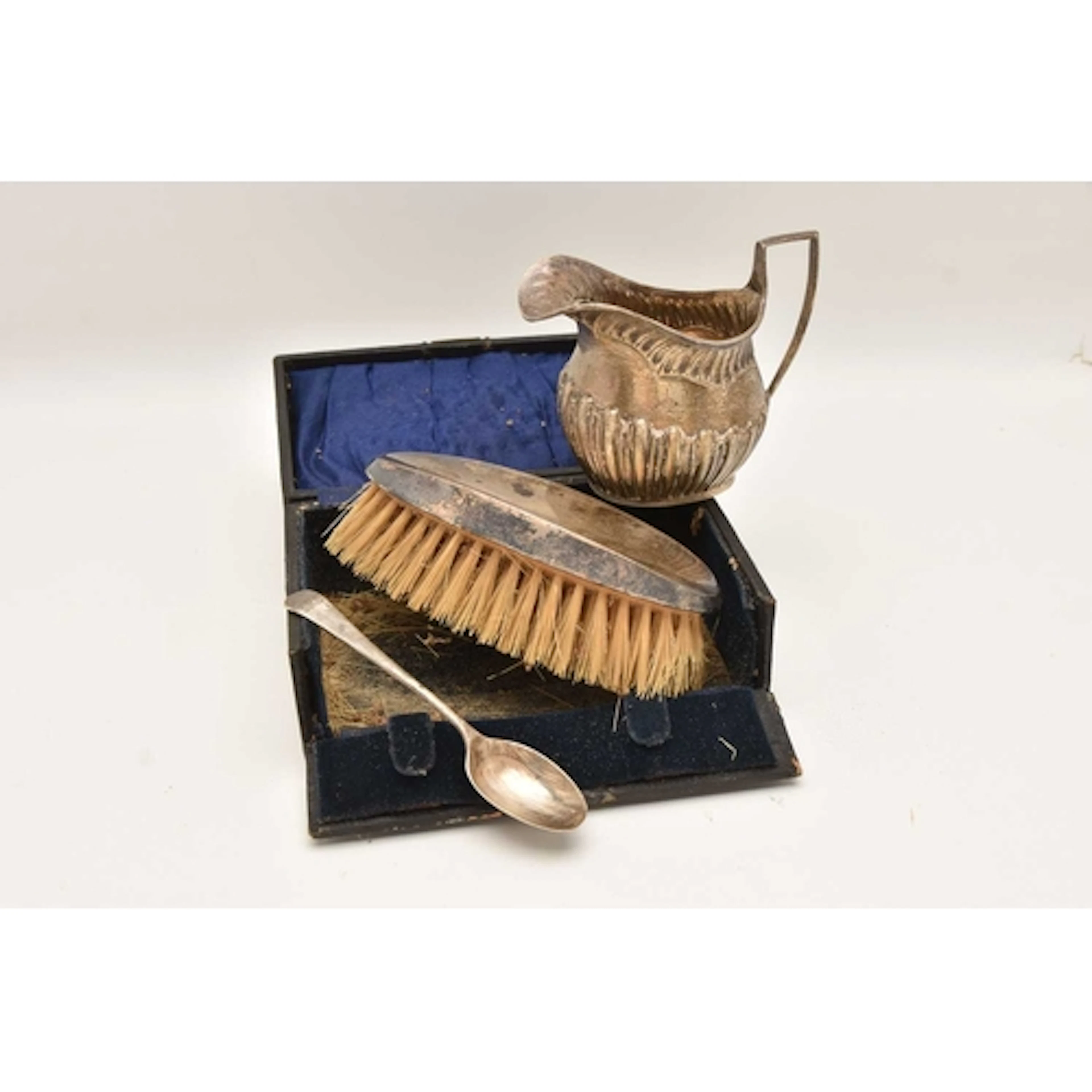 A SMALL ASSORTMENT OF SILVER, to include a milk jug, a tea s...
