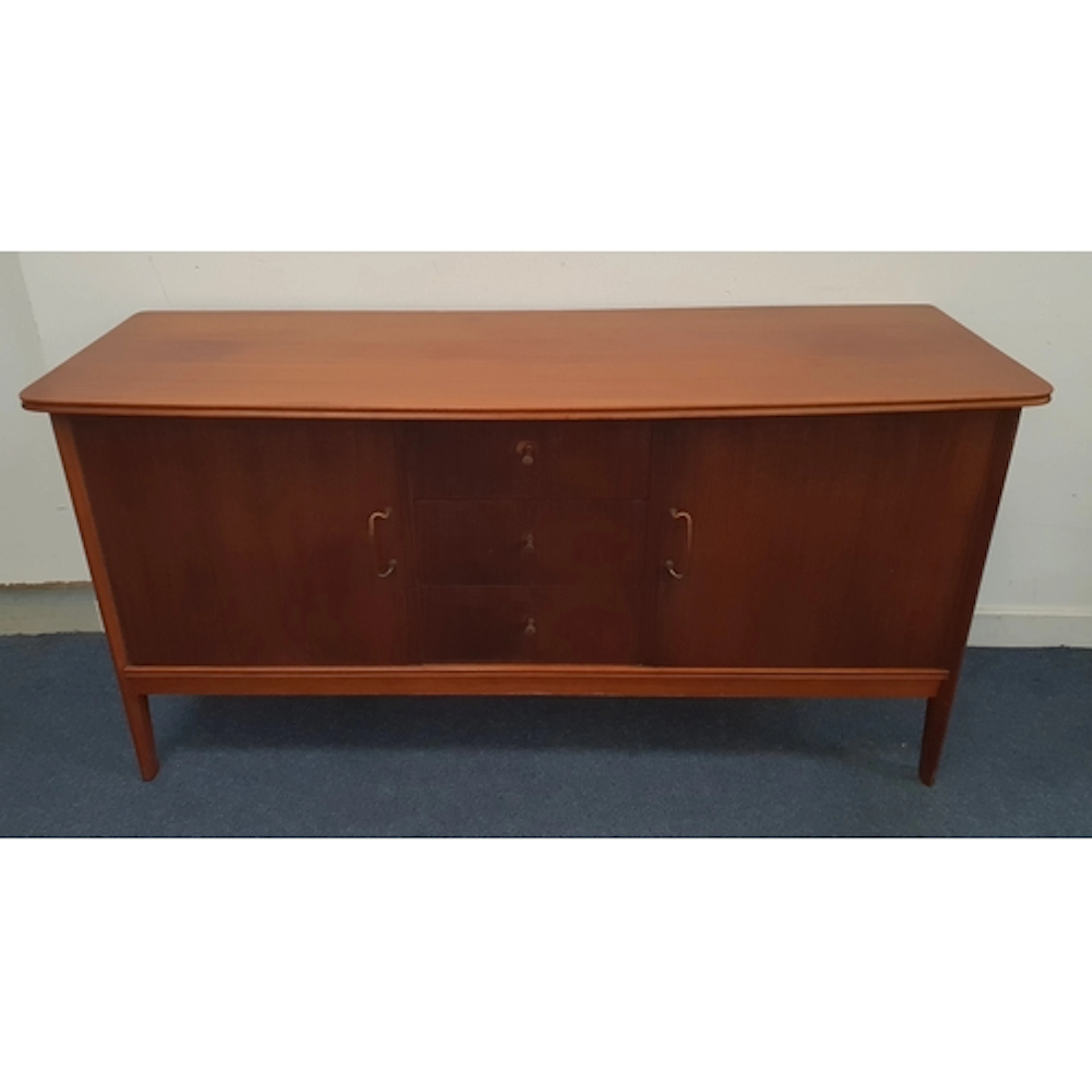 MID-CENTURY TEAK SIDEBOARD with bowed front, featuring a ce...