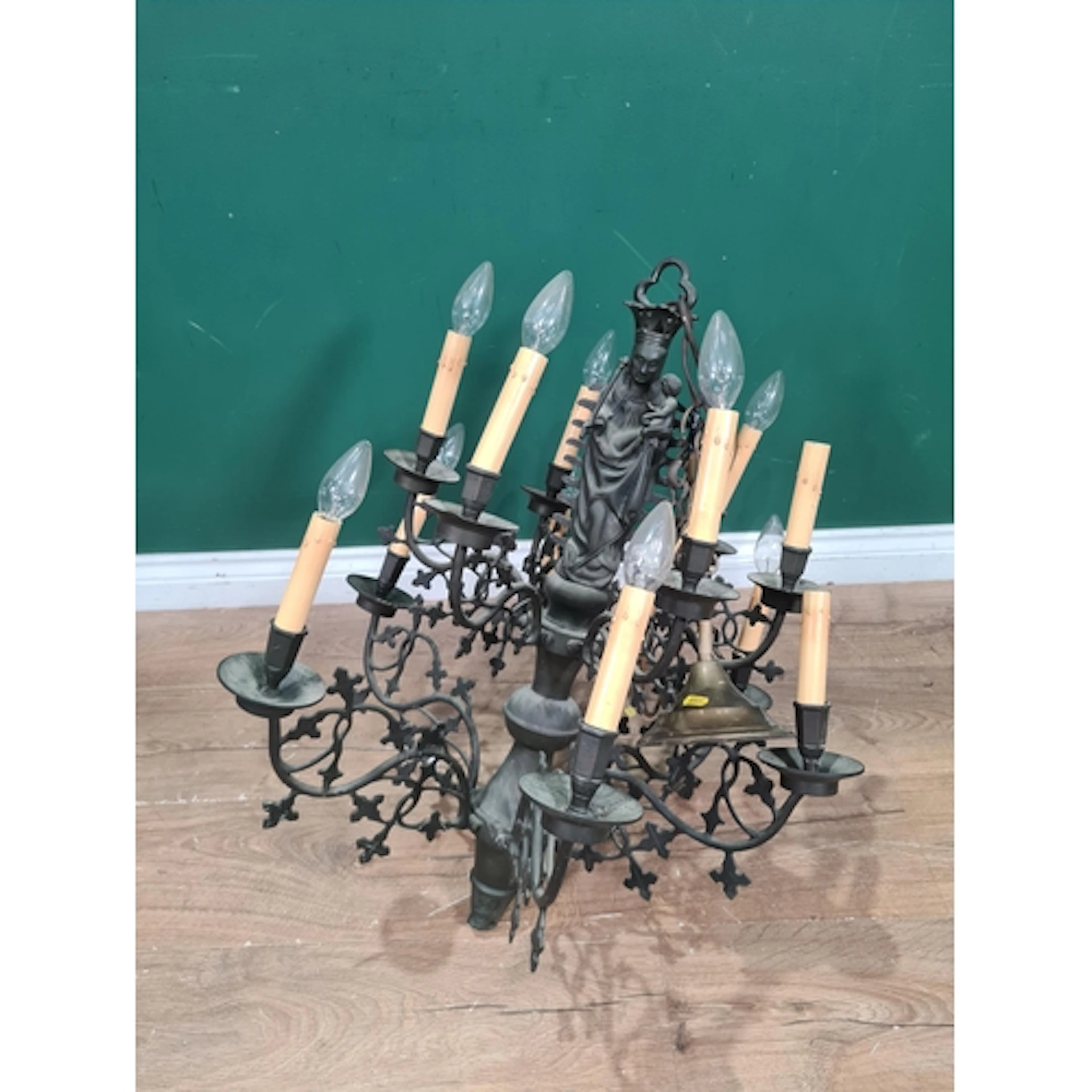 A wrought iron two-tier Electrolier with Madonna and Child t...