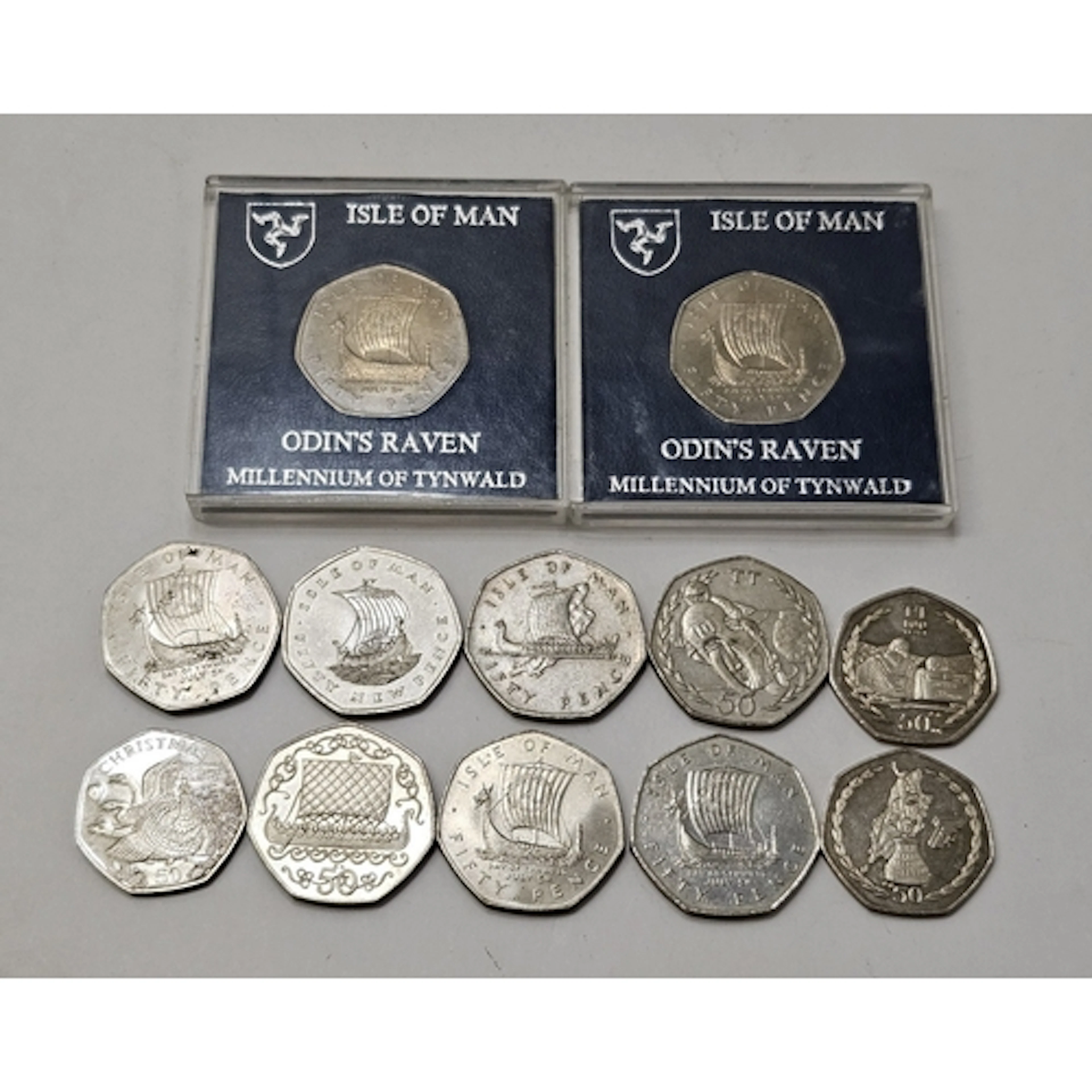 2 Odin's raven Isle of Man 50p pieces in cases, 1979 & 3 oth...
