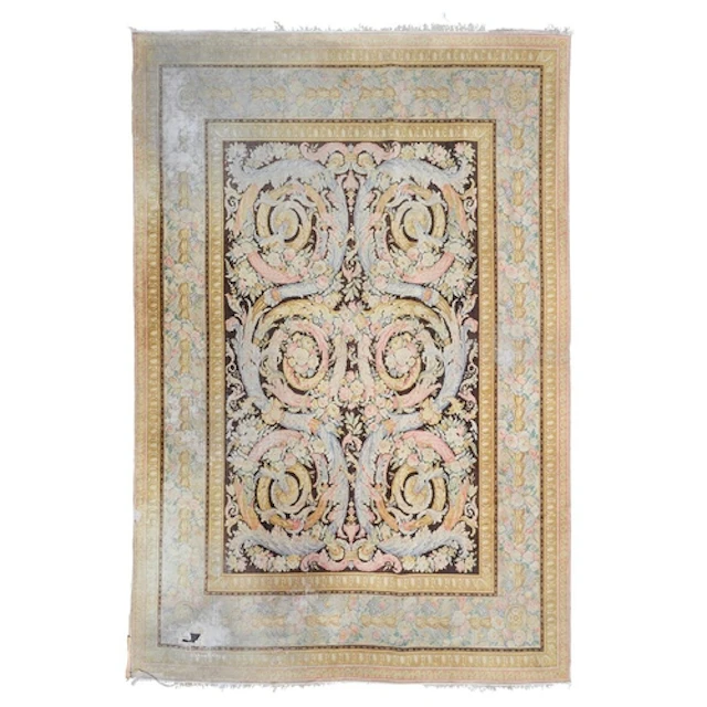 A large Savonnerie style wool rug, brown ground with rinceau...