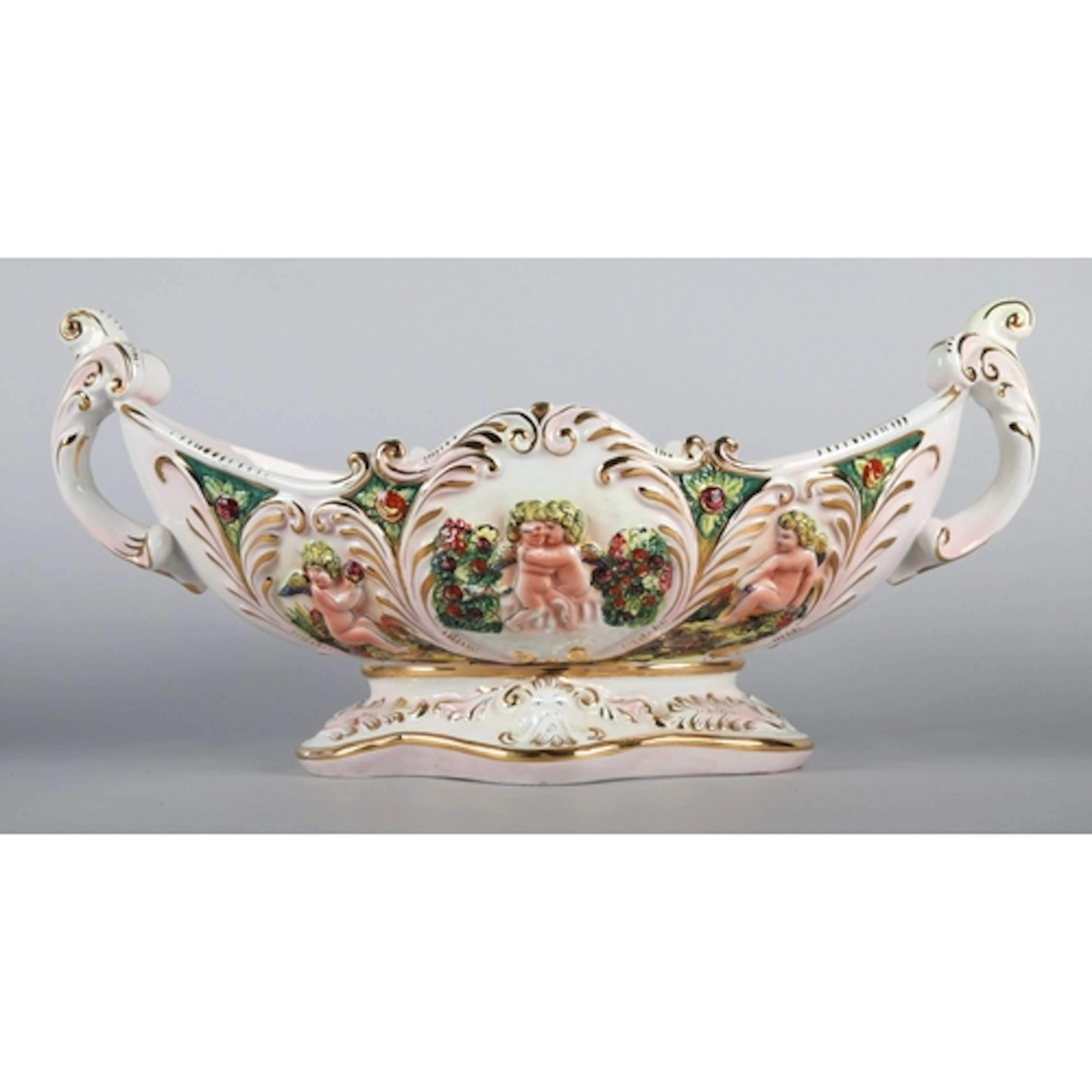 Capodimonte twin-handled dish decorated with flora and cheru...