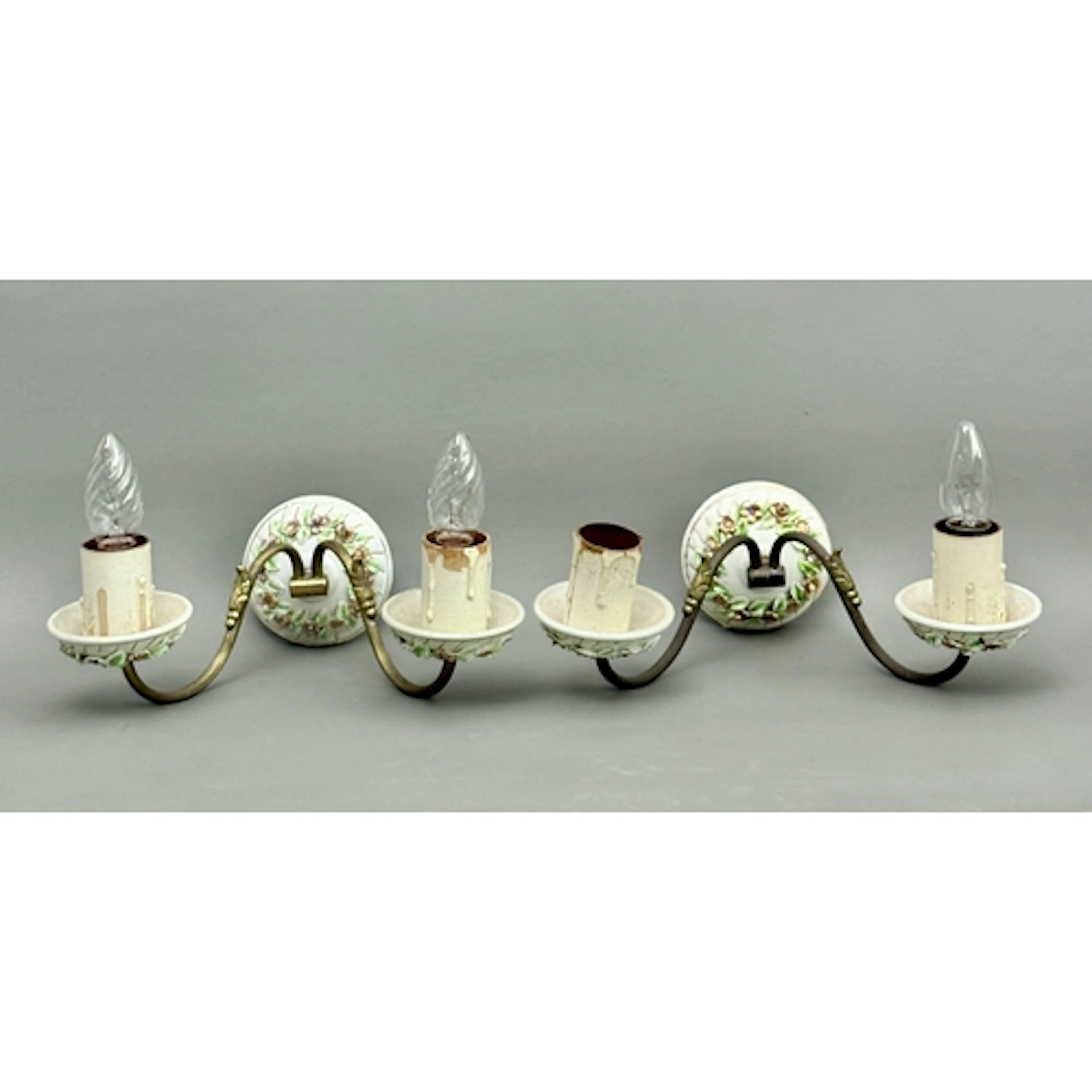 A pair of continental porcelain and brass wall lights - the ...
