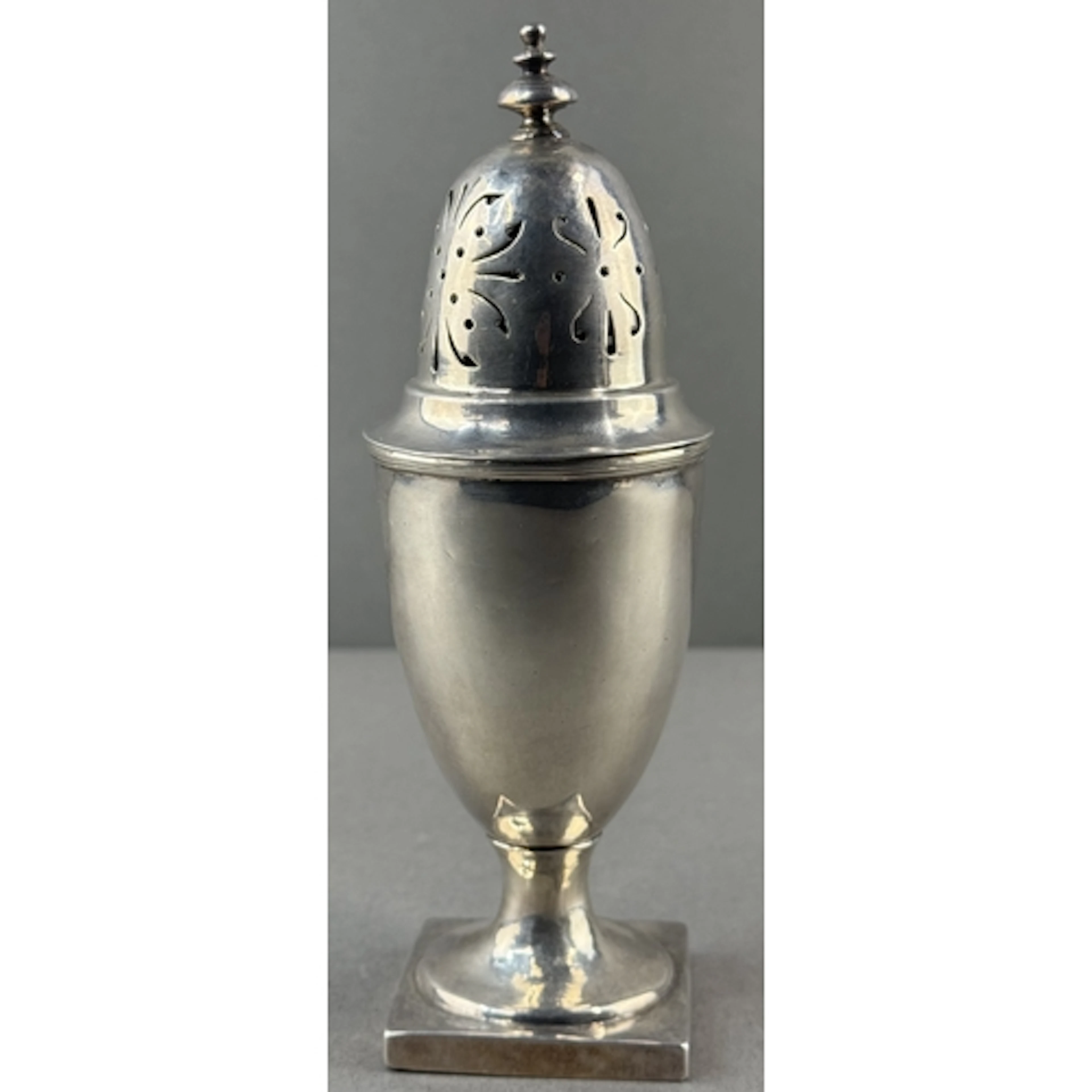 Silver: an urn shaped caster by Maurice Freeman, Britannia s...