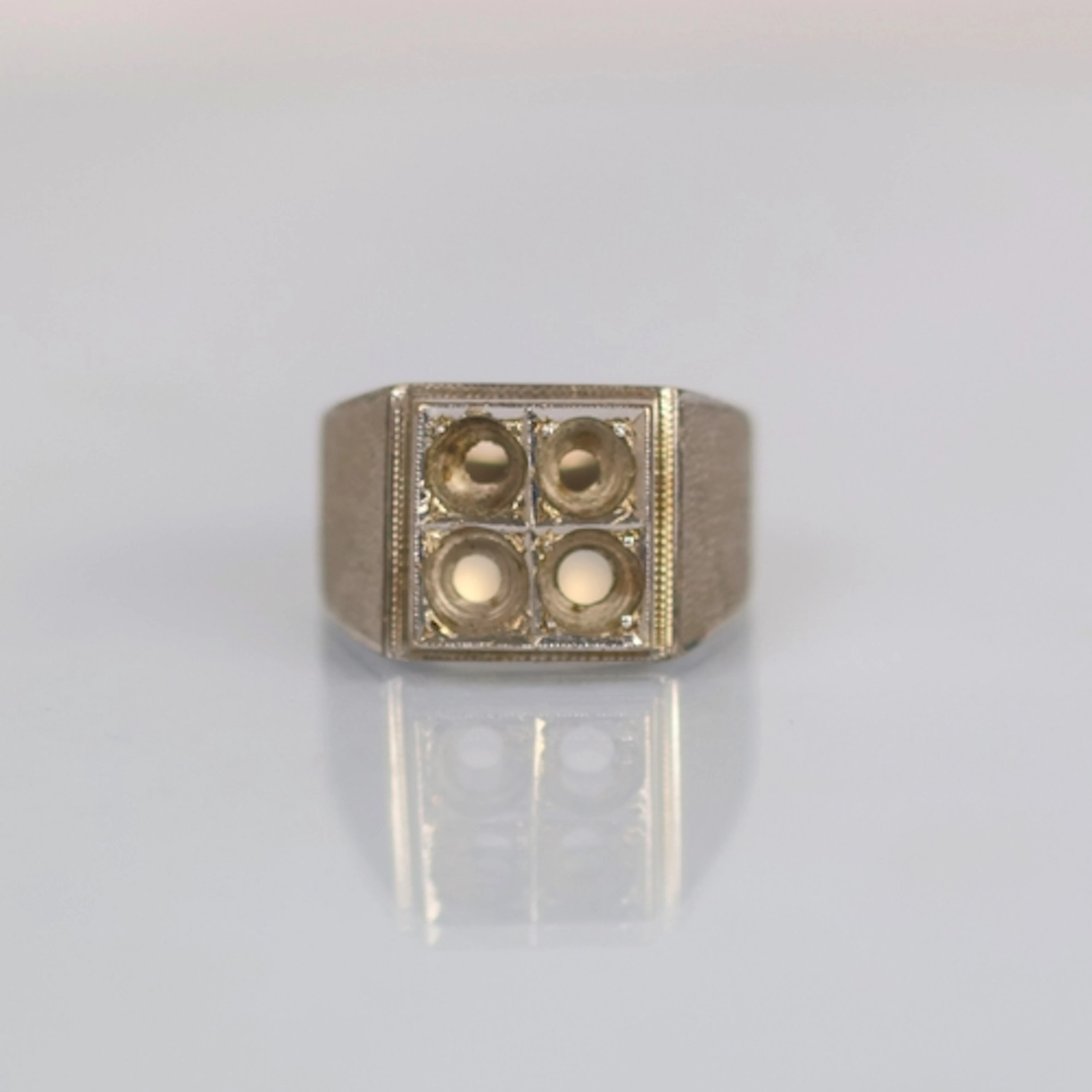 A late 20th century 'white metal' ring mount, the square hea...