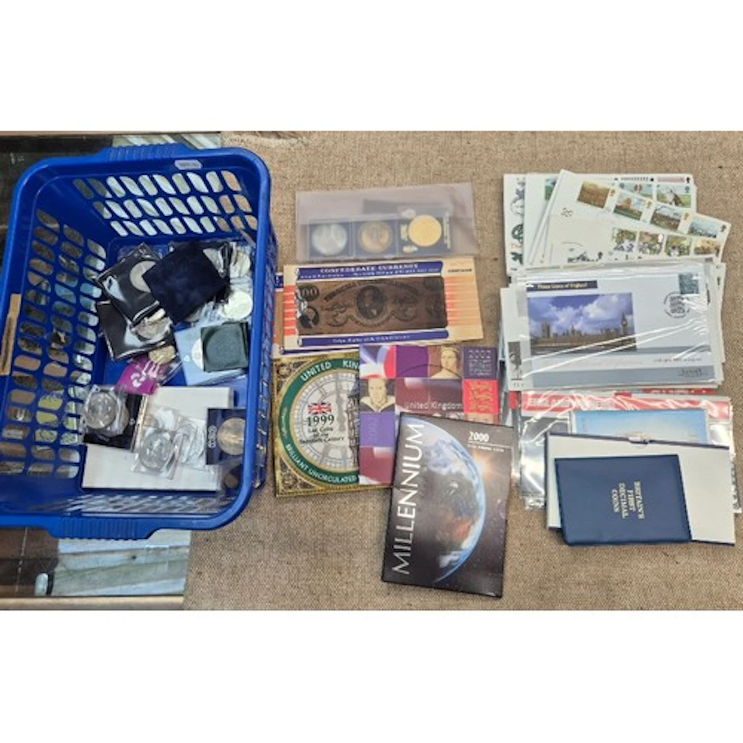 A tub of assorted coins, coin sets, first day covers & stamp...