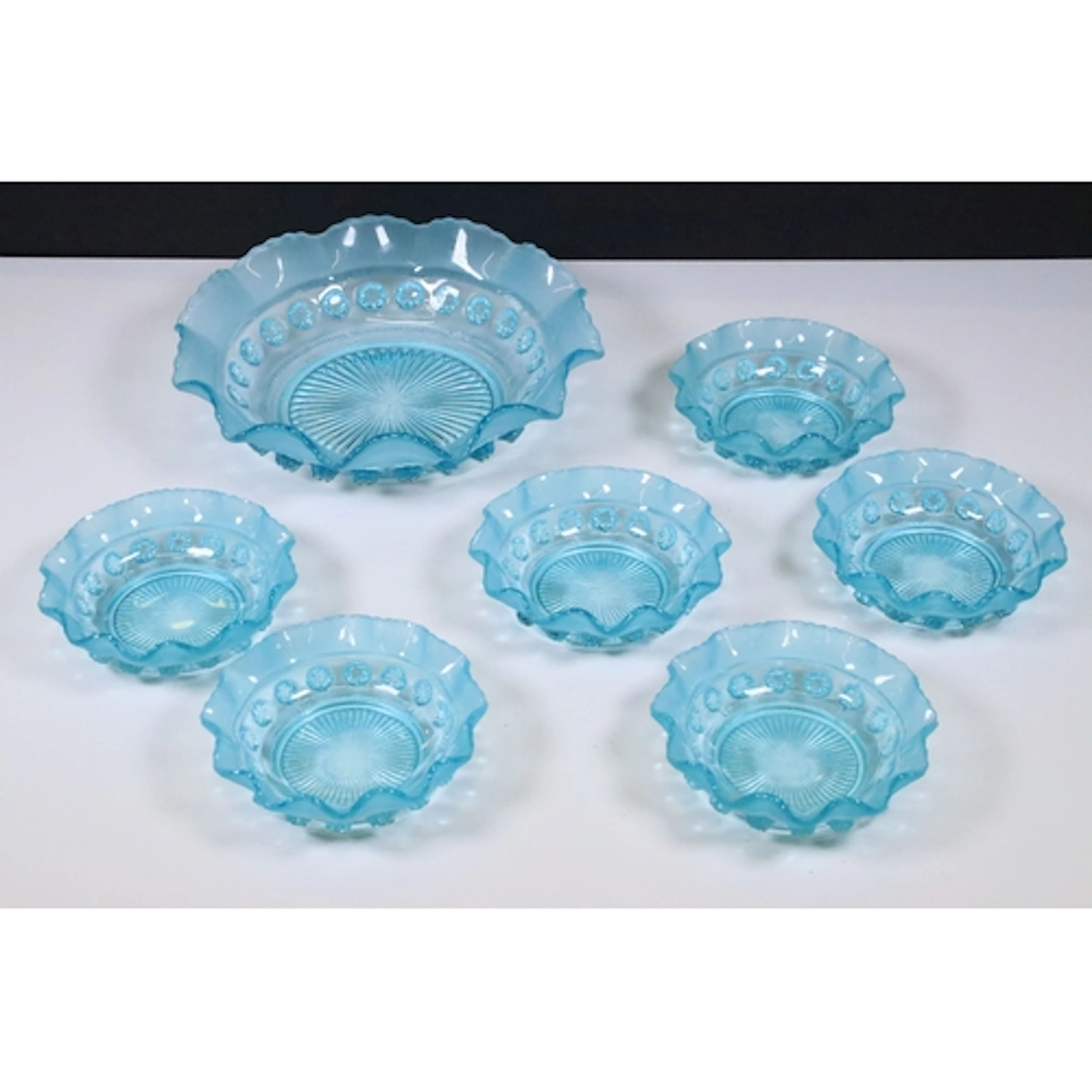Collection of early 20th century press moulded blue glass de...