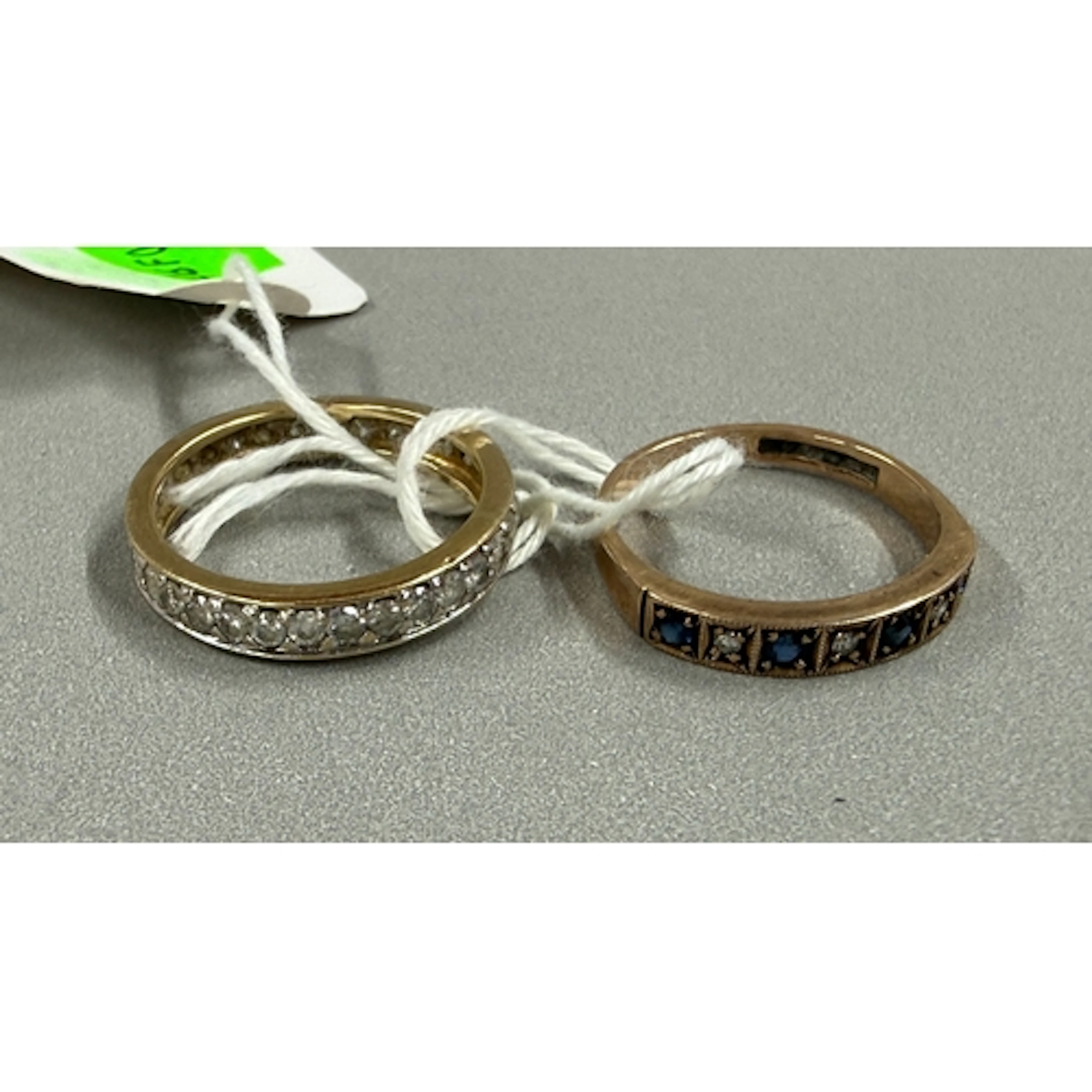 Jewellery: a 9ct rose gold ring set a row of alternating sap...