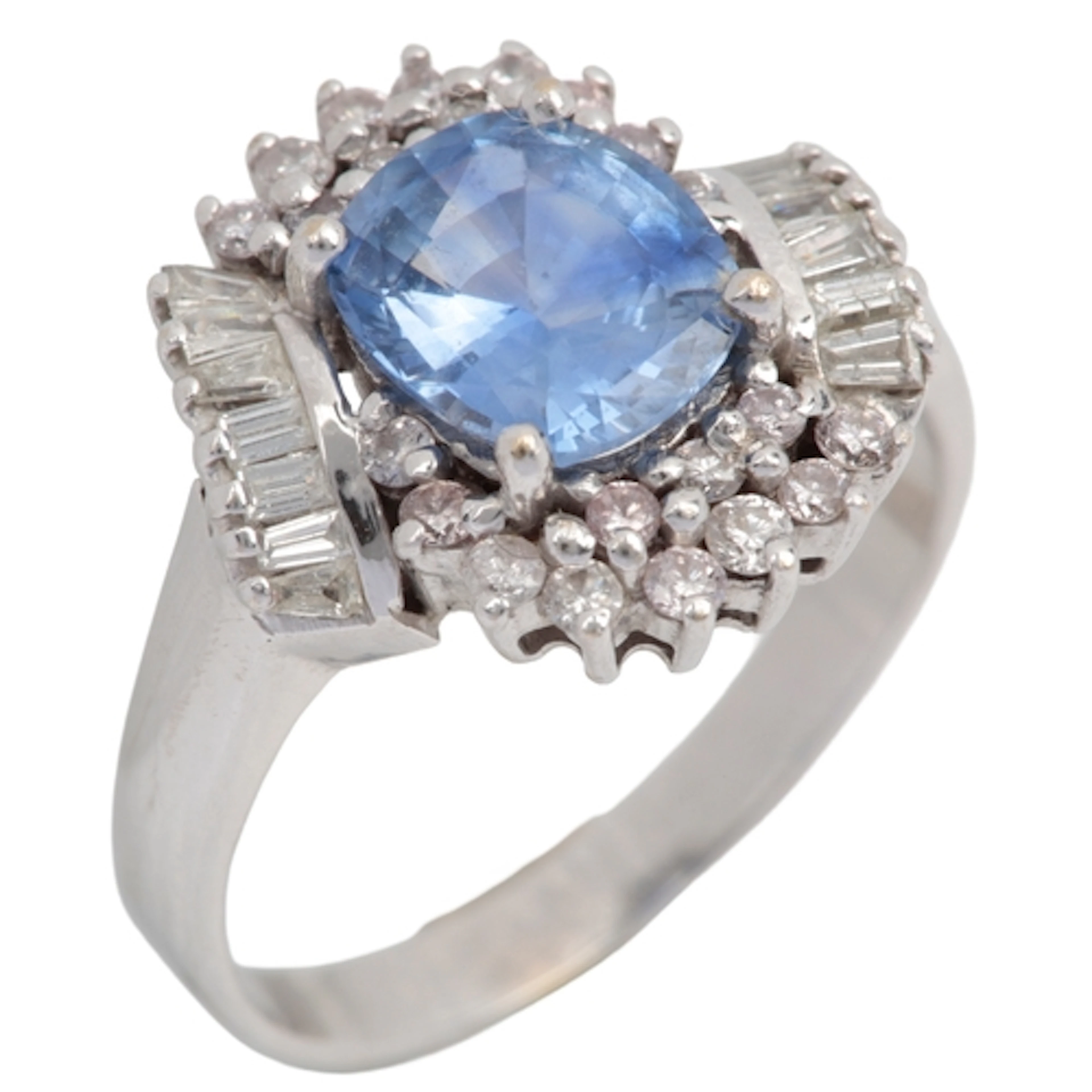 A sapphire and diamond ring, claw-set with a cushion-shaped ...