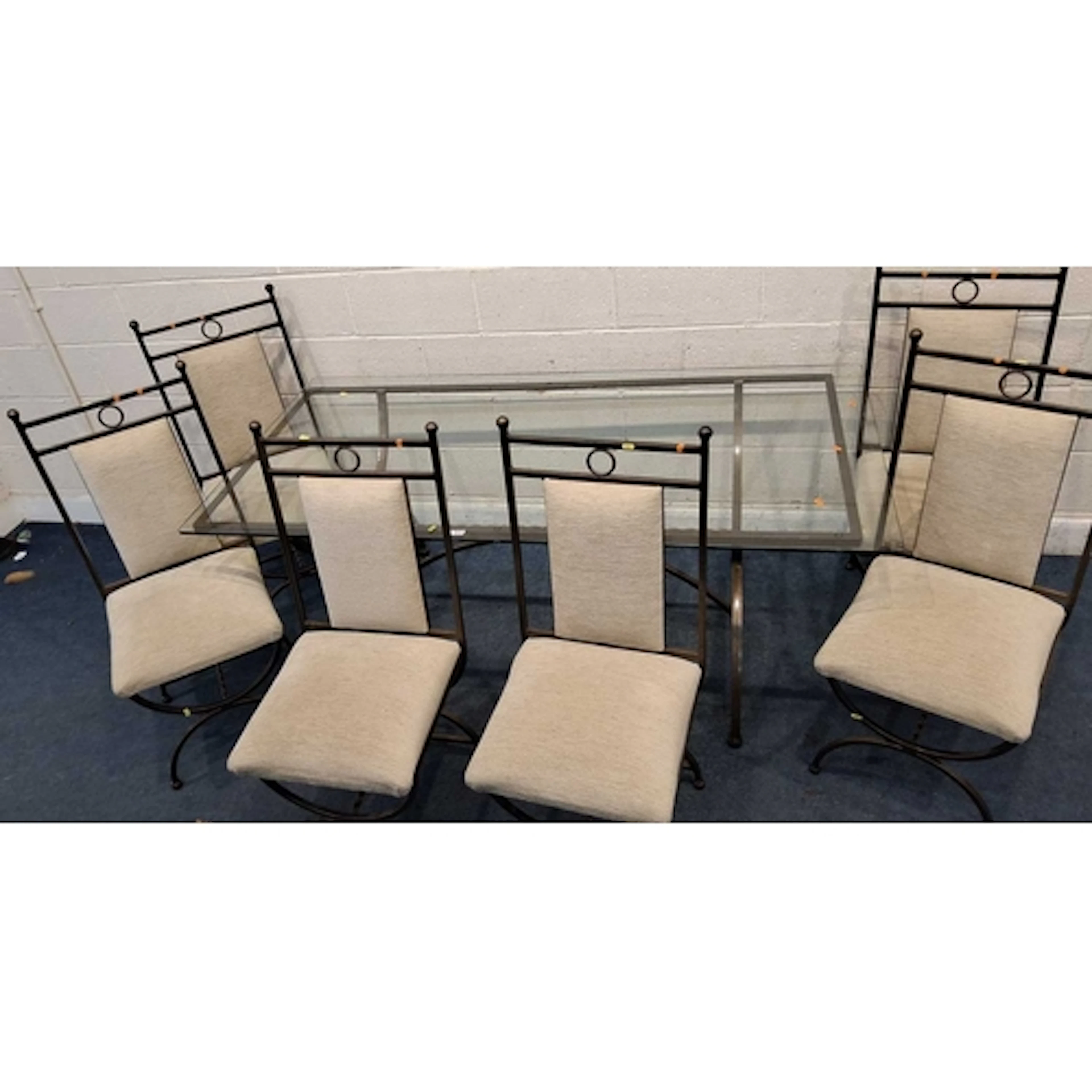 A TUBULAR METAL RECTANGULAR TABLE, with a glass top, raised ...