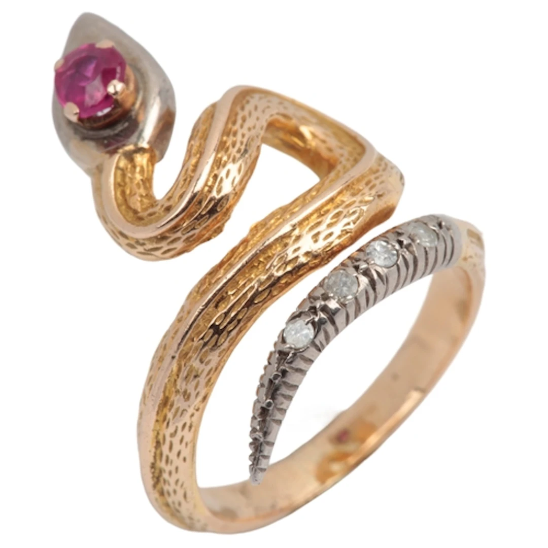 A synthetic ruby and diamond ring, designed as a coiled snak...