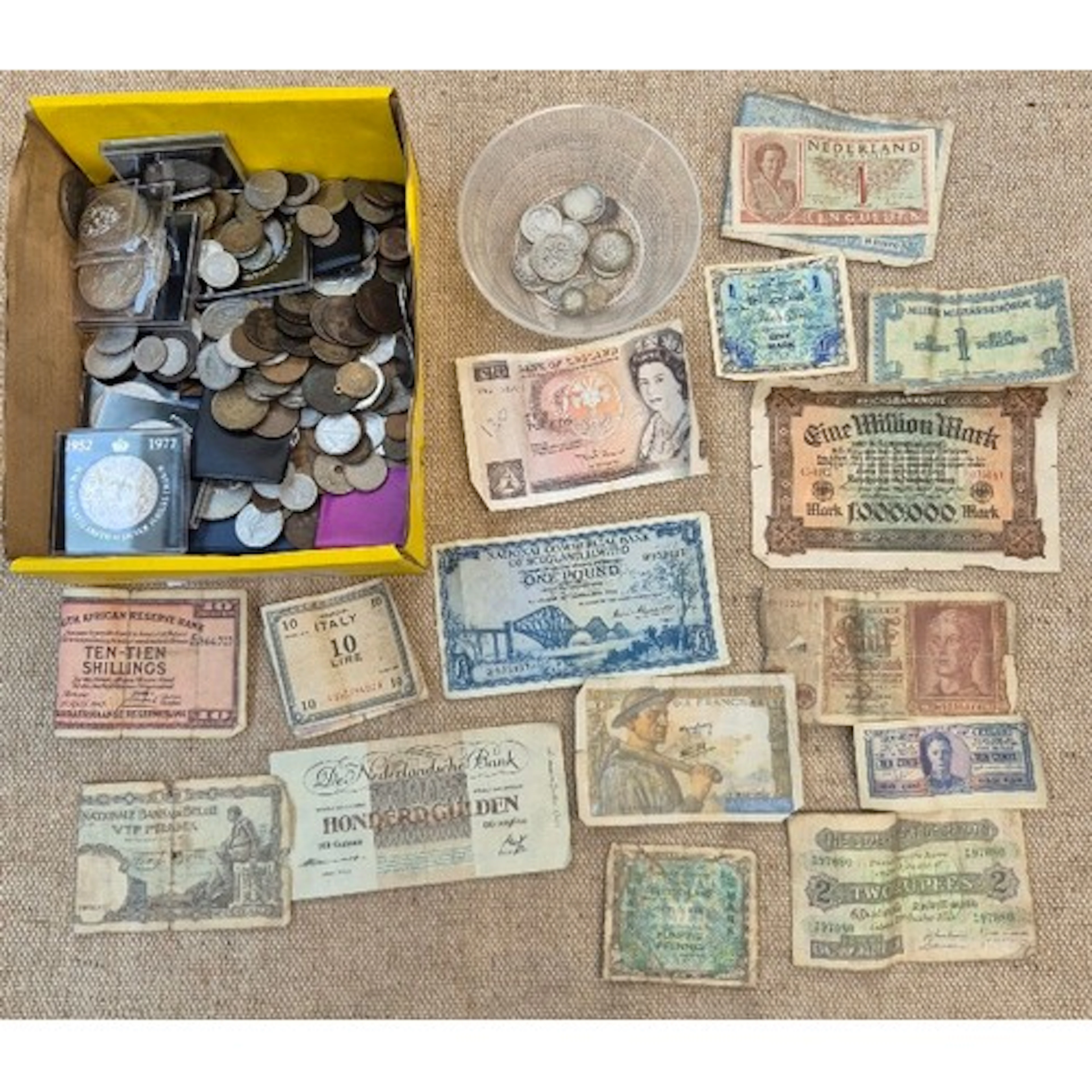 A box of assorted world coins & banknotes.