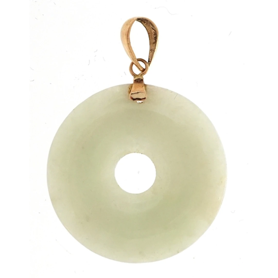 Chinese green stone disc pendant with yellow metal bail, 2.2...