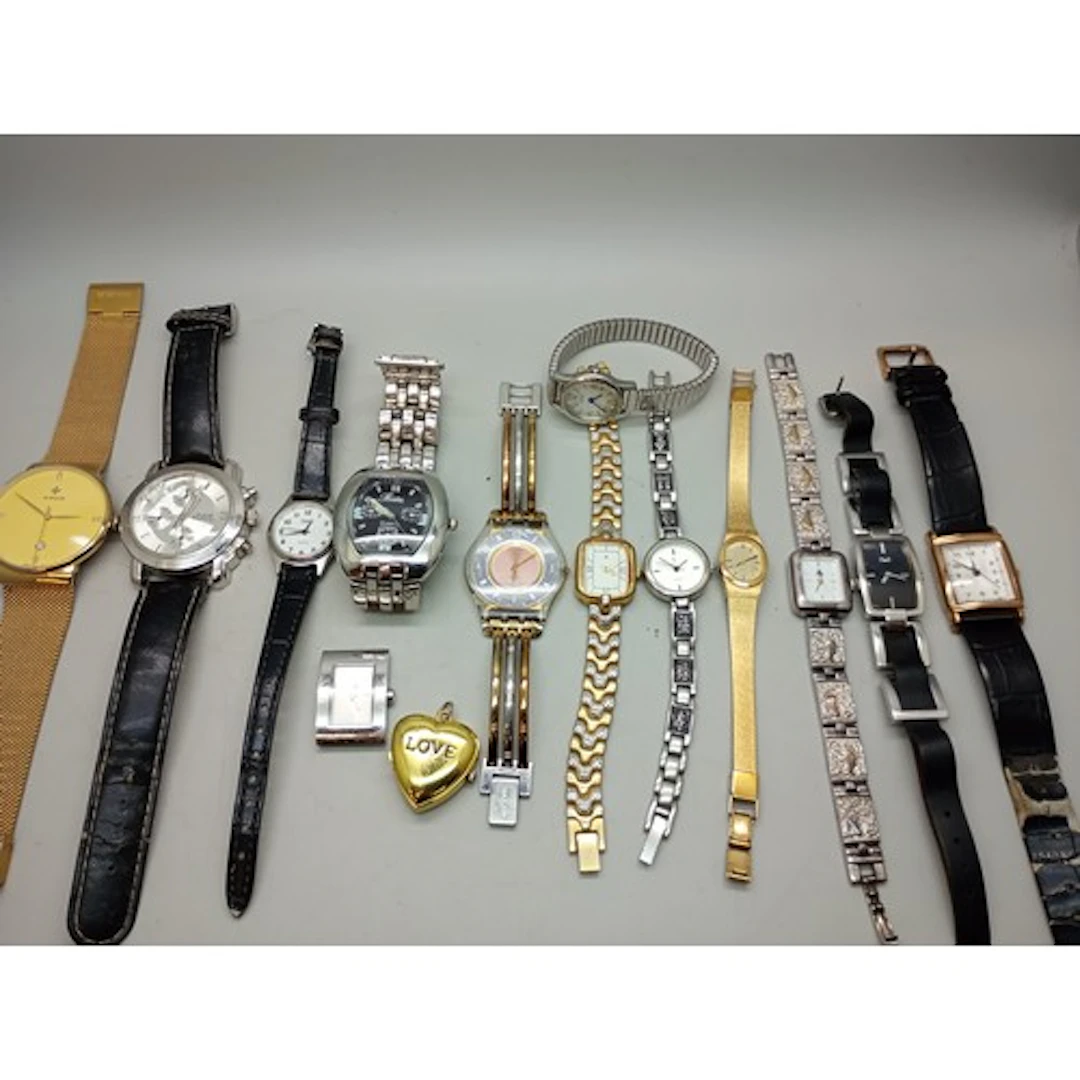 A collection of fashion watches, a Swatch watch, and a silve...