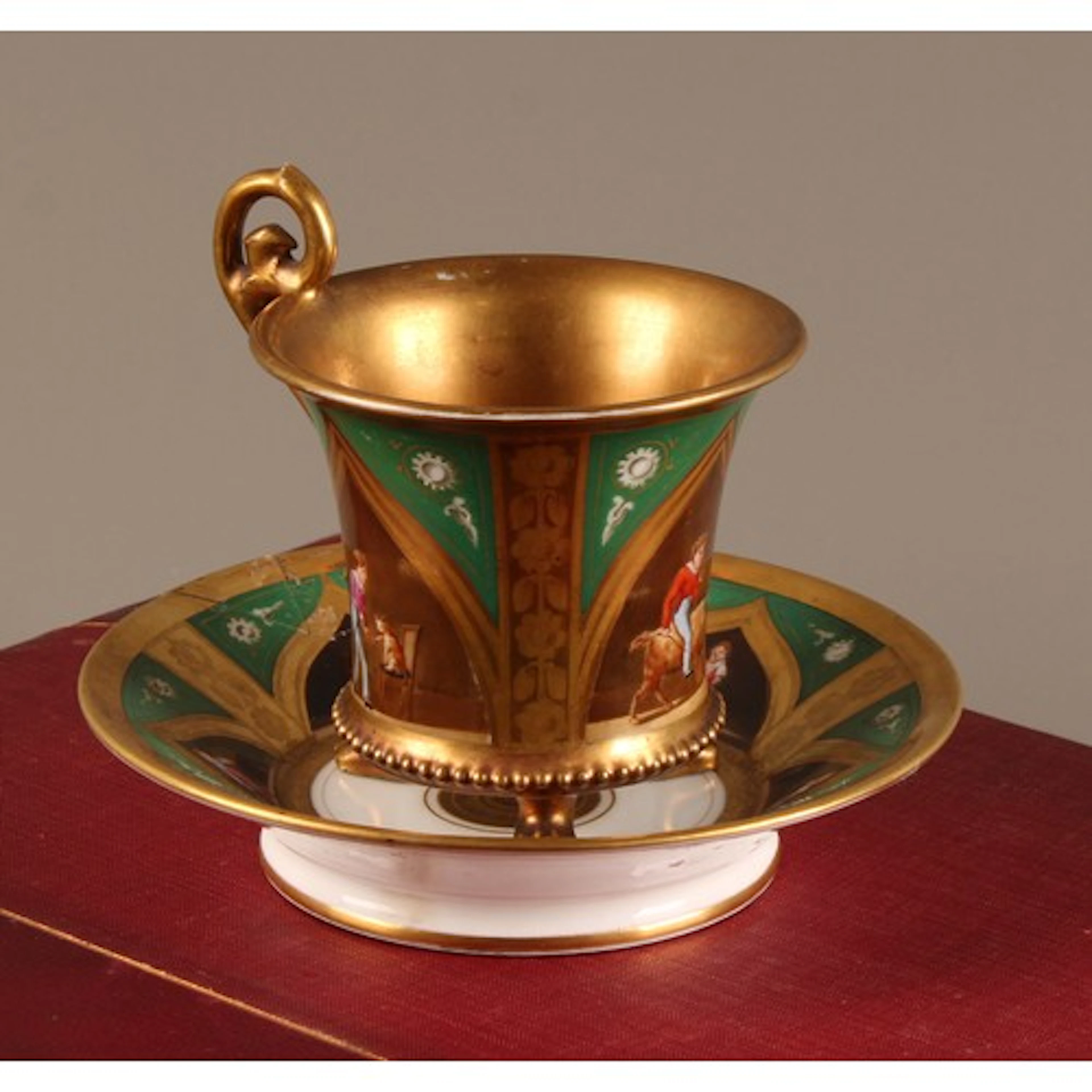 A Darte Frères footed cabinet cup and saucer, painted with c...