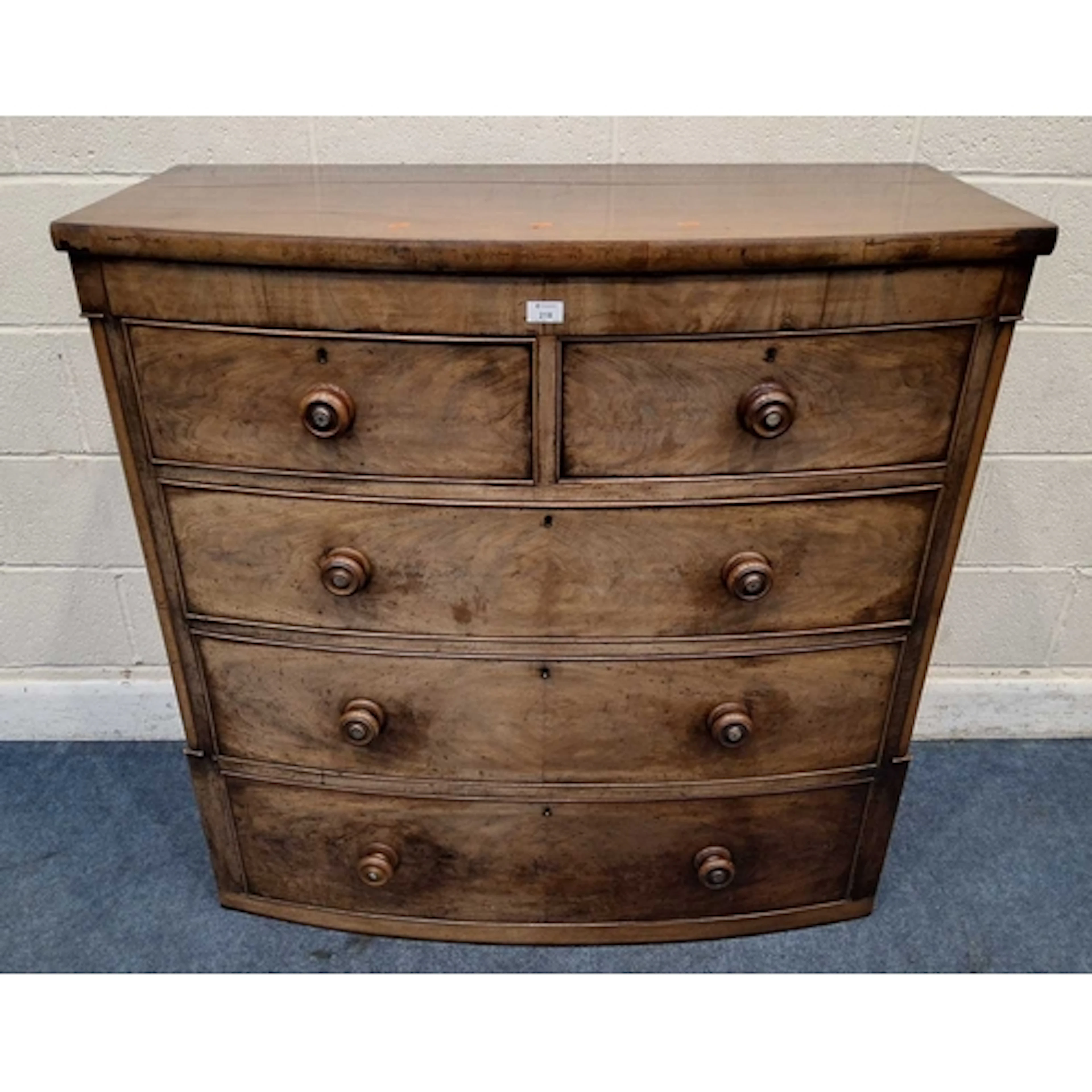 A 19TH CENTURY MAHOGANY BOW FRONT CHEST OF TWO SHORT OVER TH...
