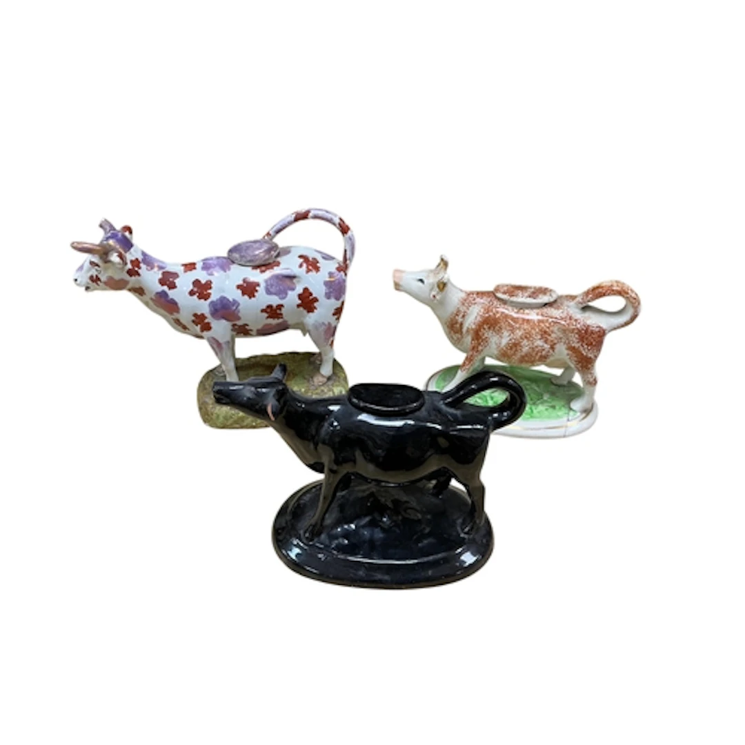Three 19th century Staffordshire cow creamers