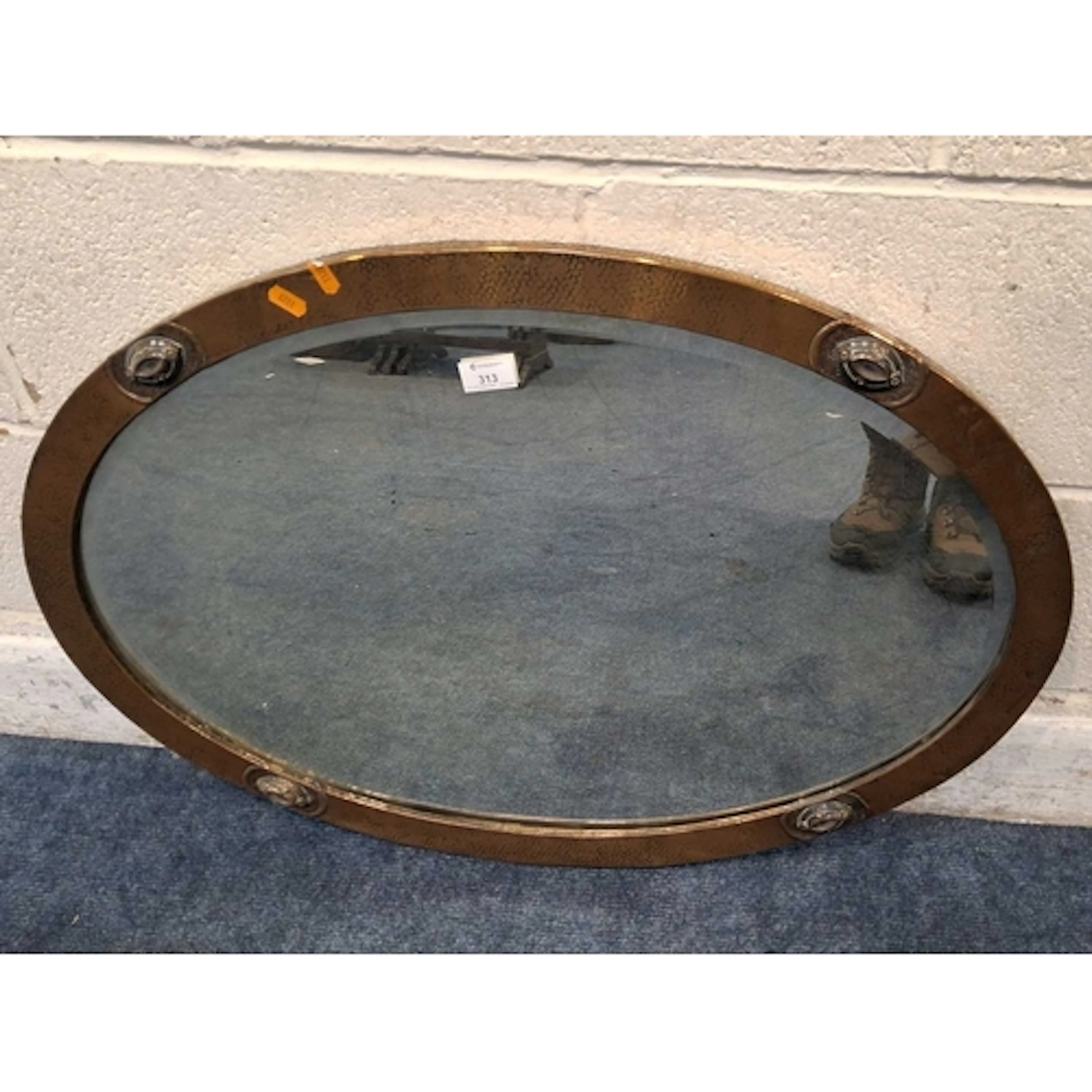 AN OVAL COPPER FRAME BEVELED EDGE WALL MIRROR (83cm x 58cm)...