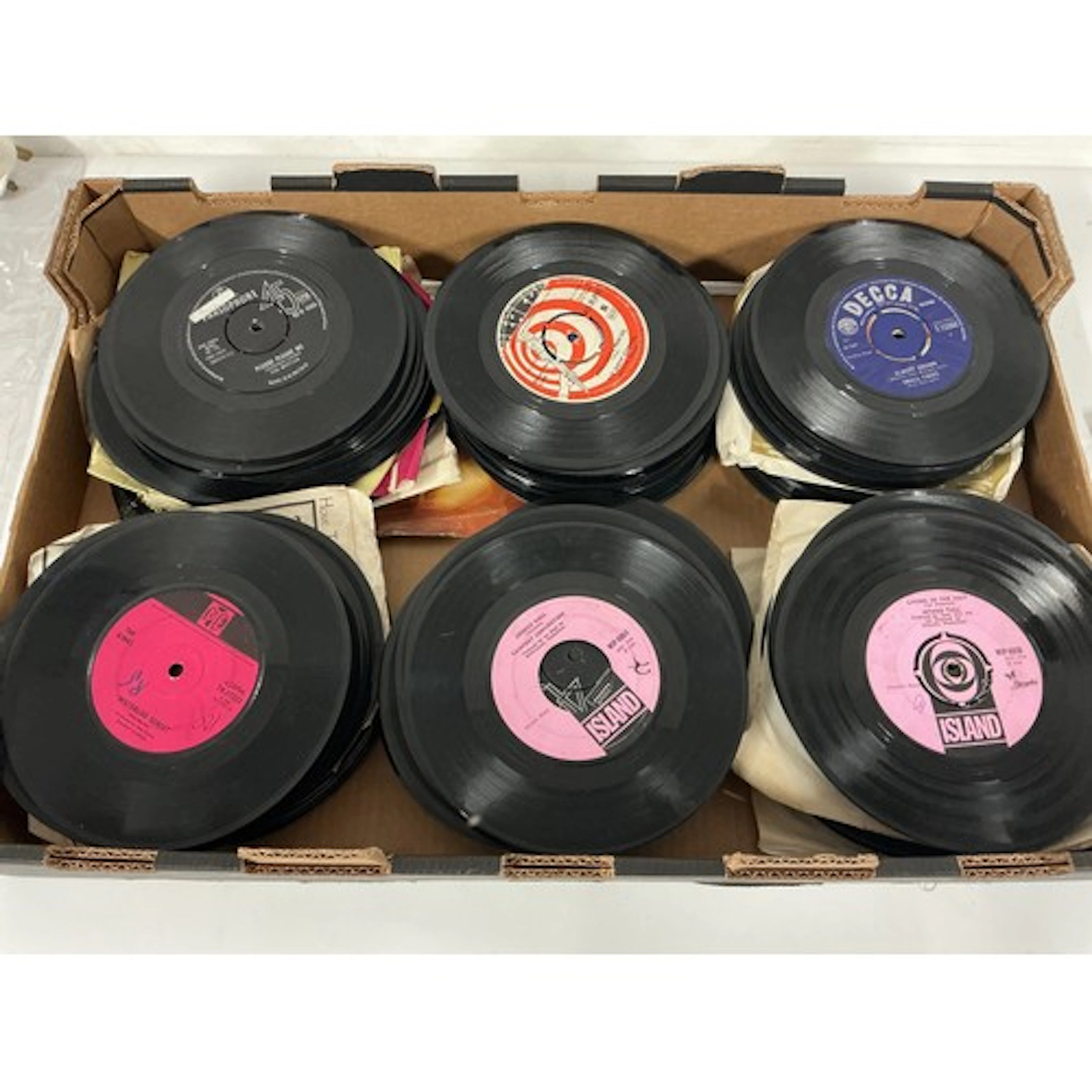 A collection of 7” singles and EPs by various artists includ...