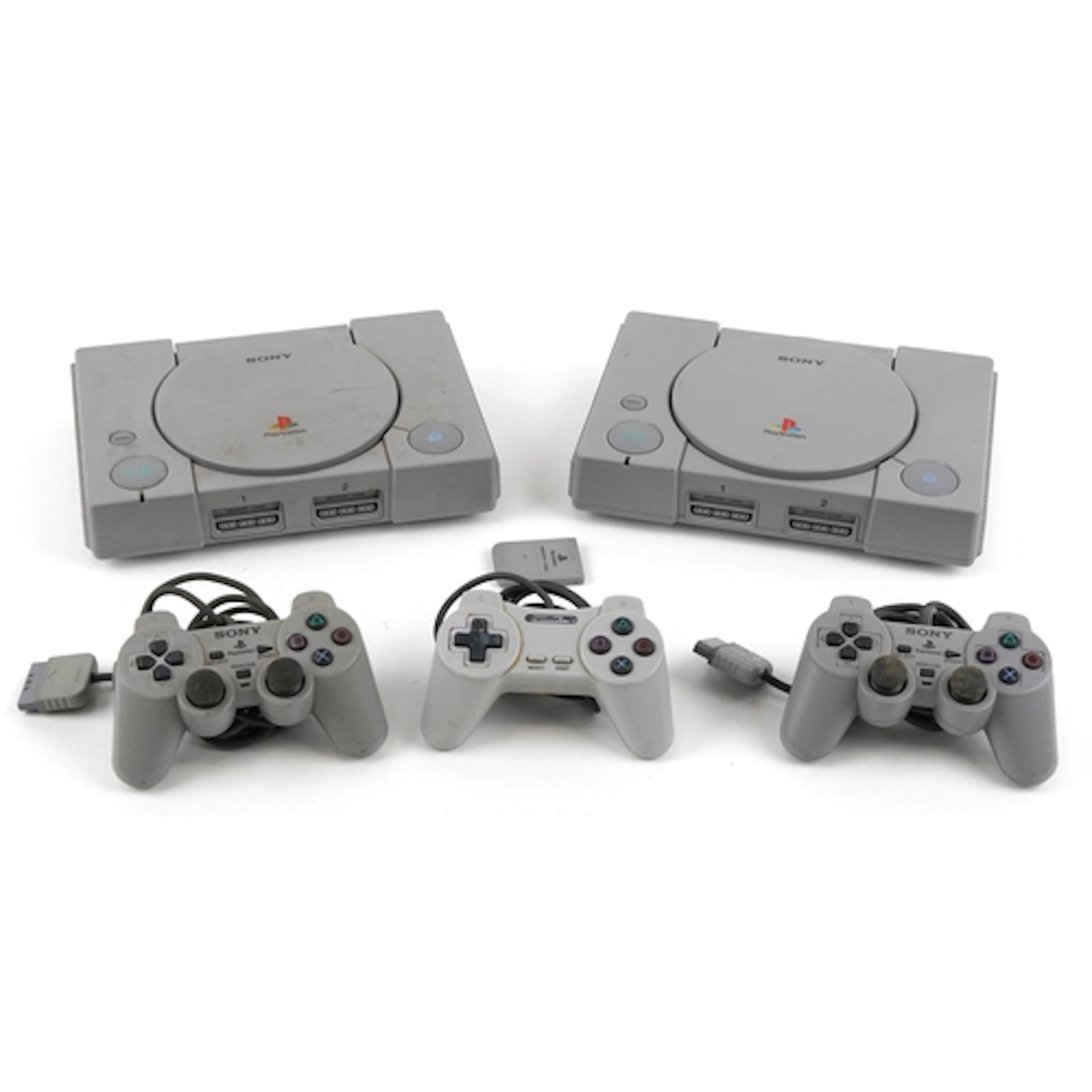 Two Sony PlayStation games consoles with three controllers.