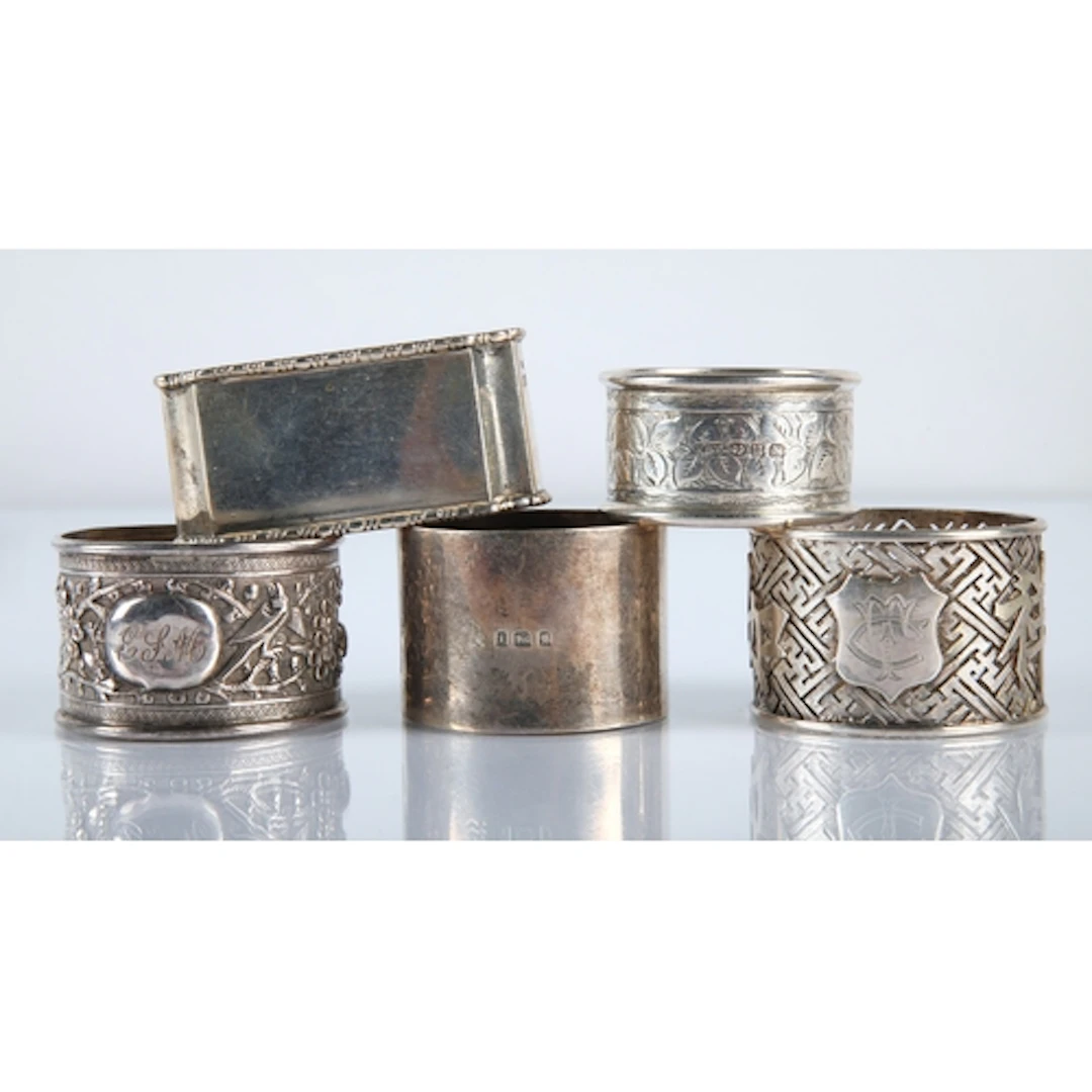 Five silver engraved napkin rings, gross weight 129.9g.