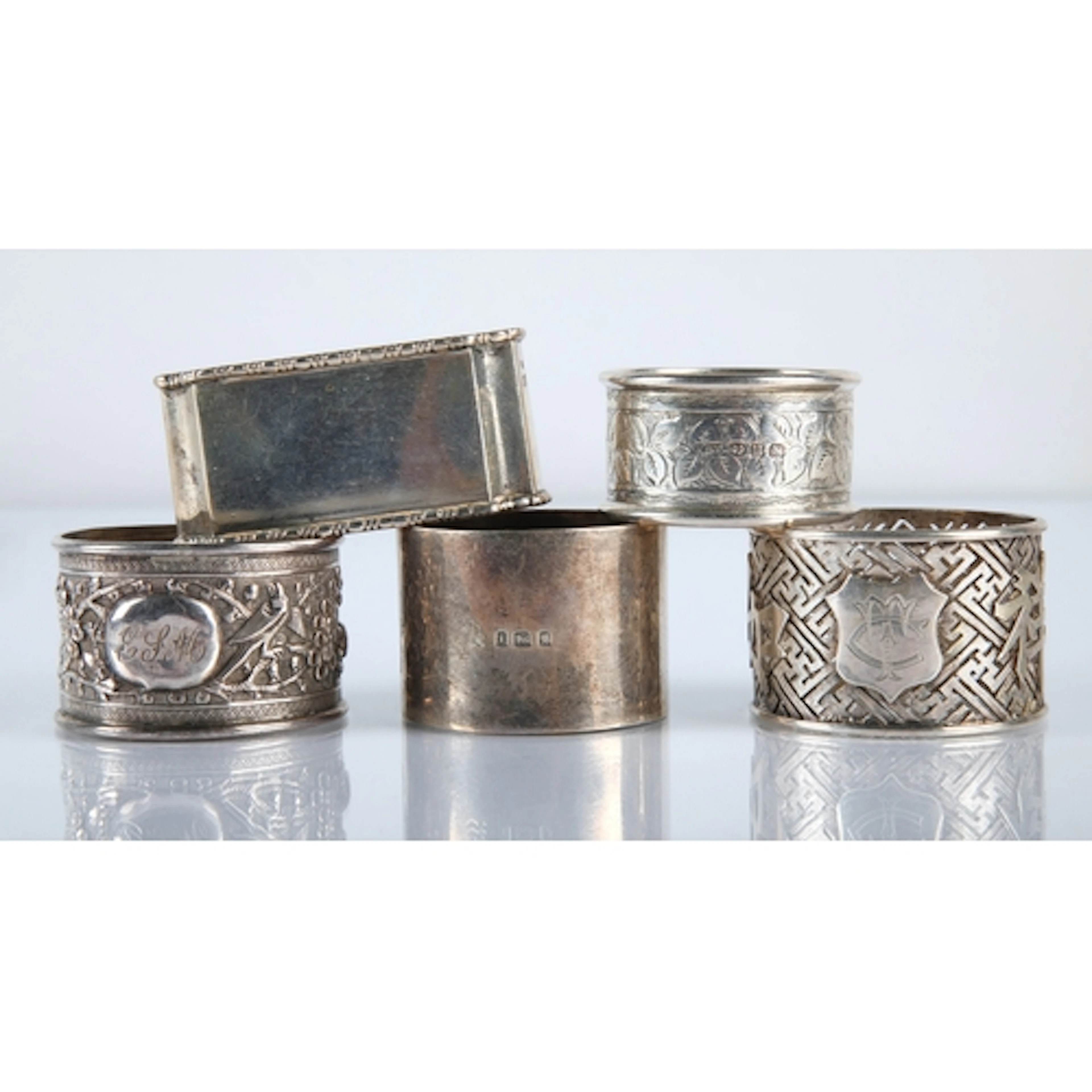 Five silver engraved napkin rings, gross weight 129.9g.