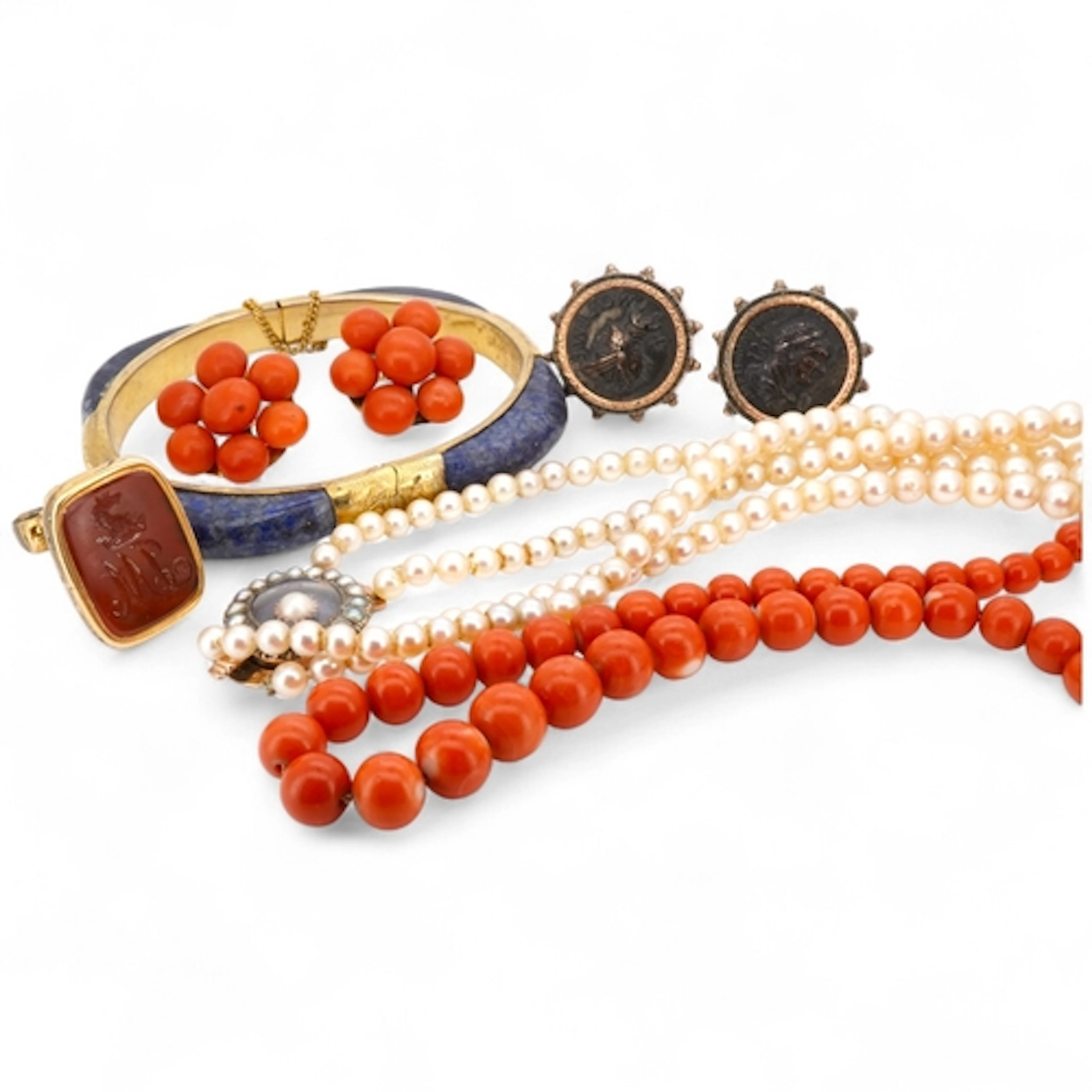 A collection of jewels including a coral demi-parure, compri...